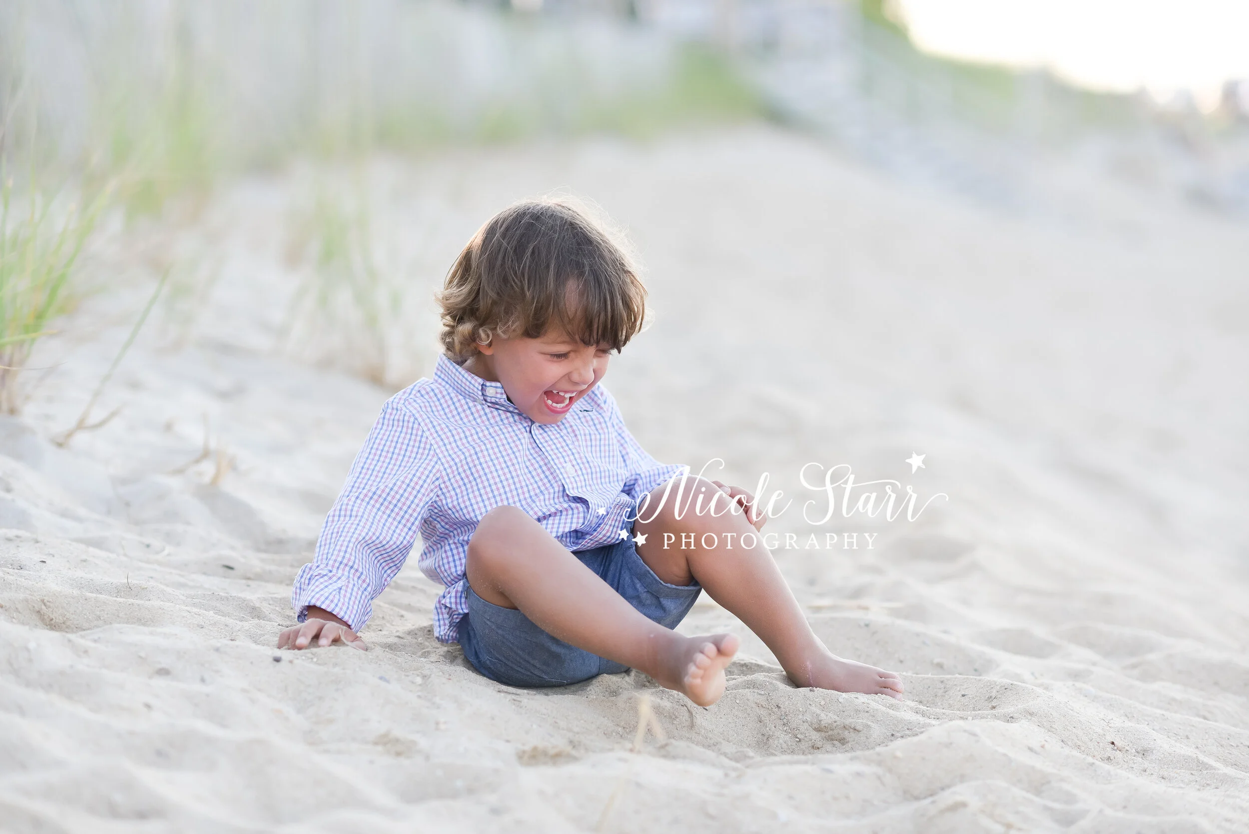 child plays in sand on beach in Massachusetts during family photos with Cape Cod family photographer Nicole Starr Photography