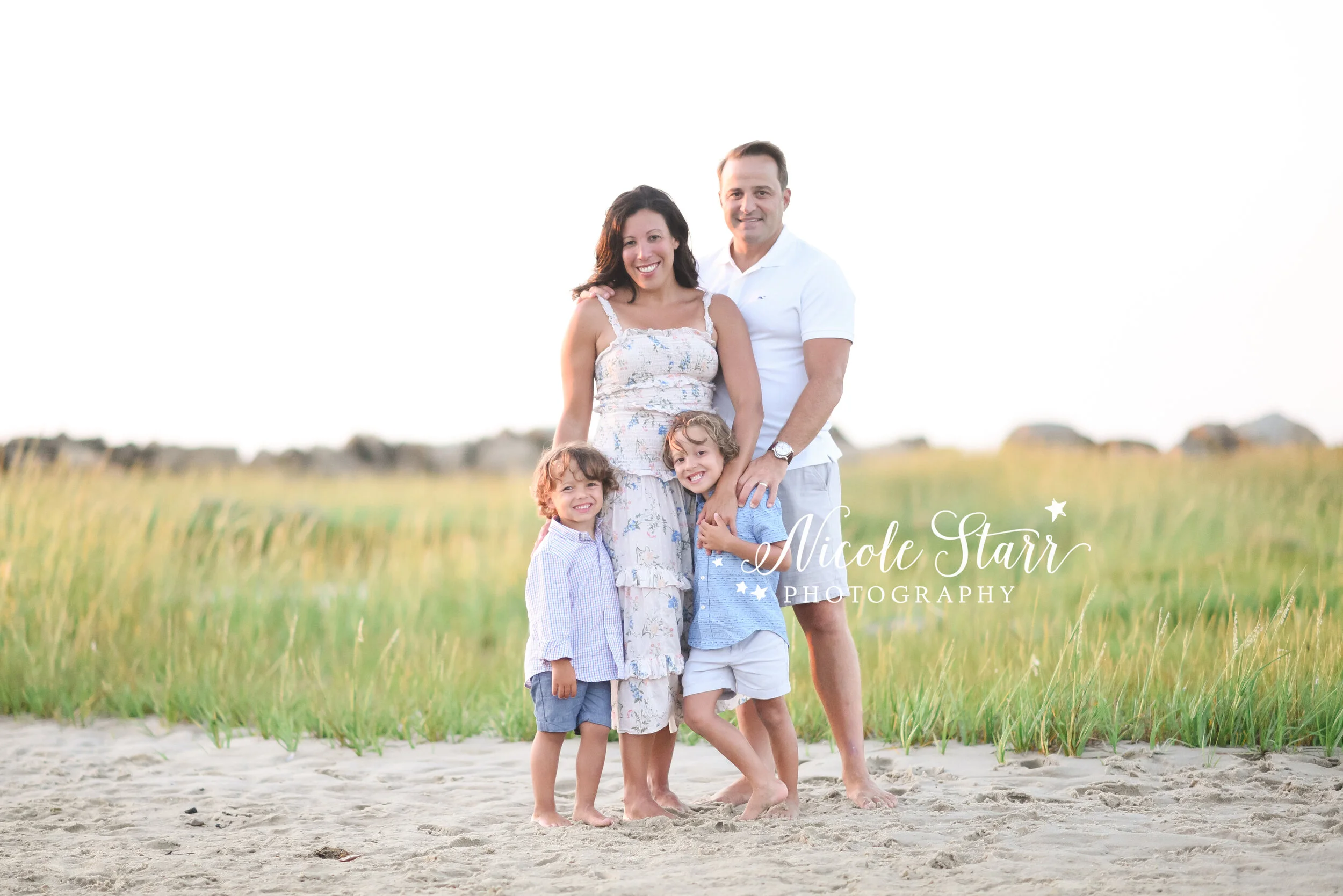 Corporation Beach family portraits of family in light blue and white outfits photographed by Cape Cod family photographer Nicole Starr Photography