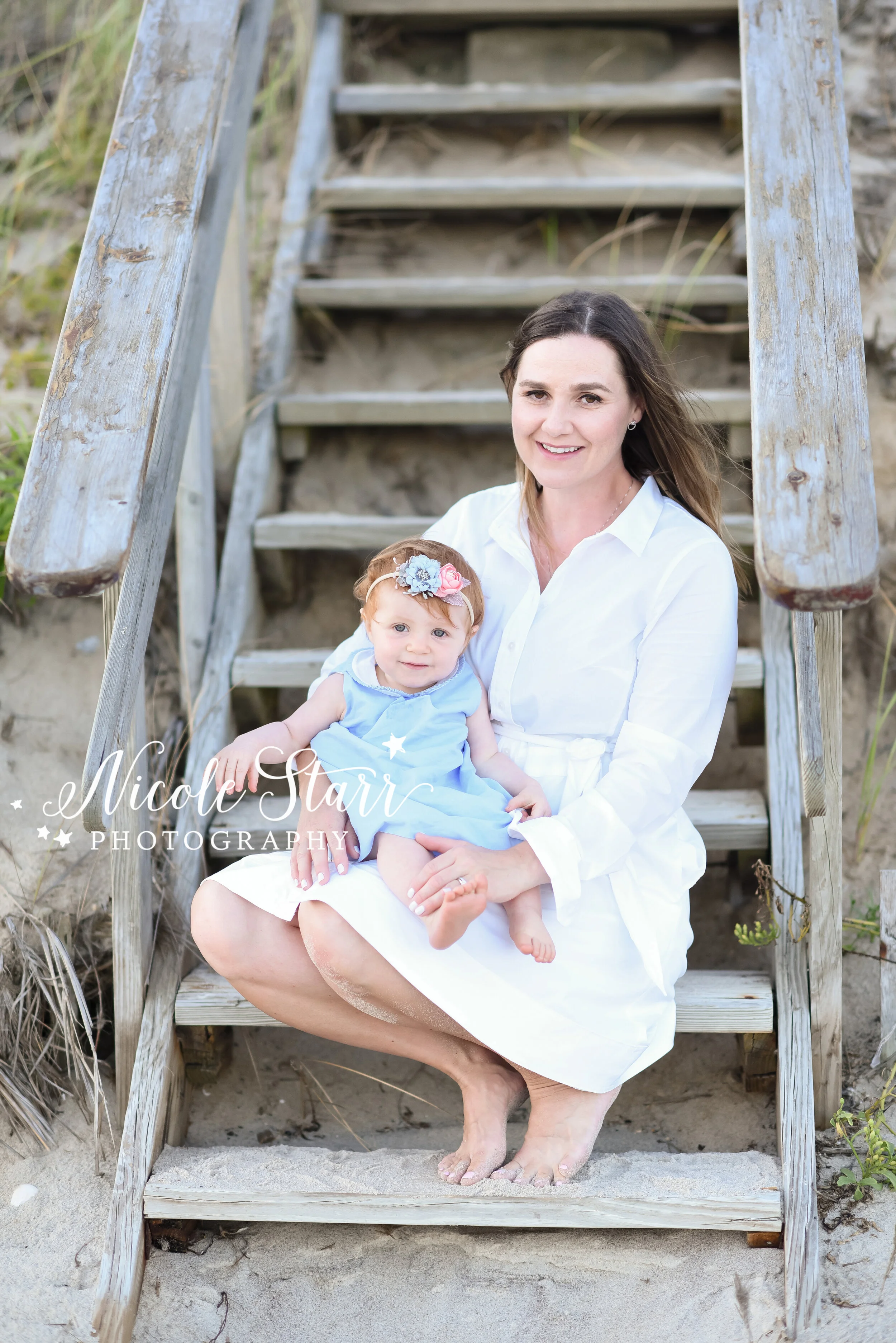 mom poses with birthday girl on wooden steps at beach with Cape Cod beach family photographer Nicole Starr Photography