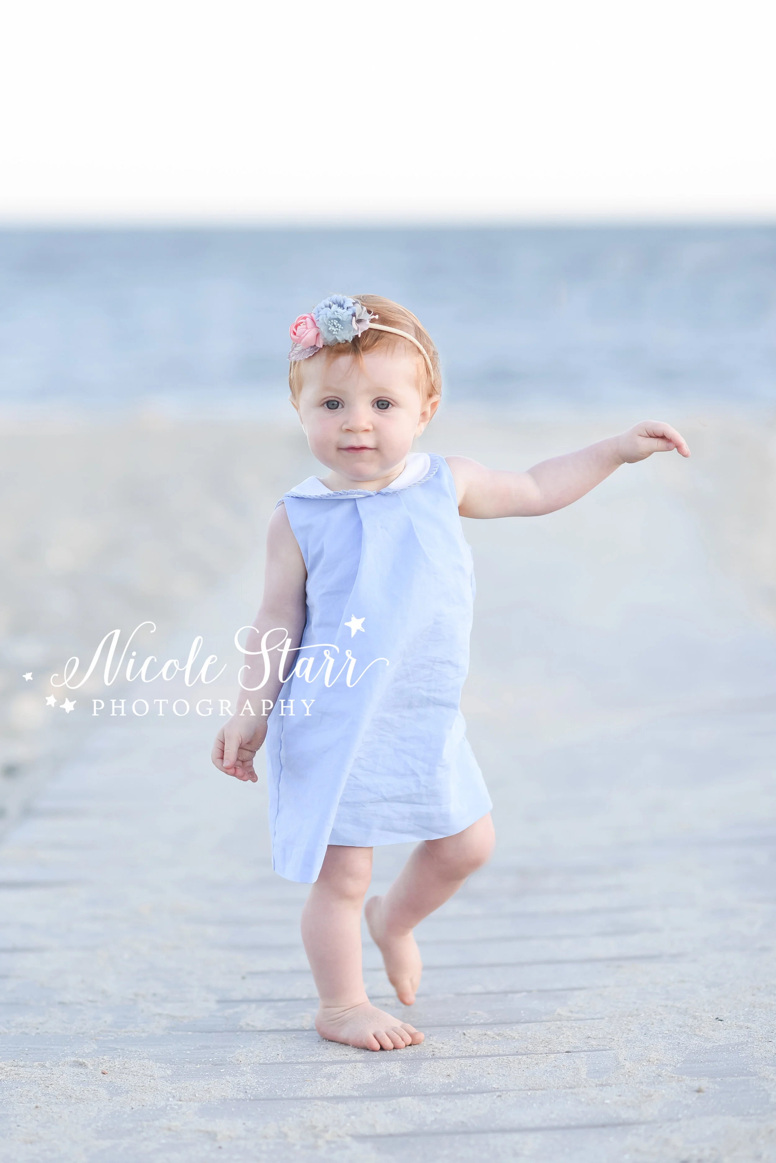 tdler plays in the sand during milestone portraits with Cape Cod beach family photographer Nicole Starr Photography