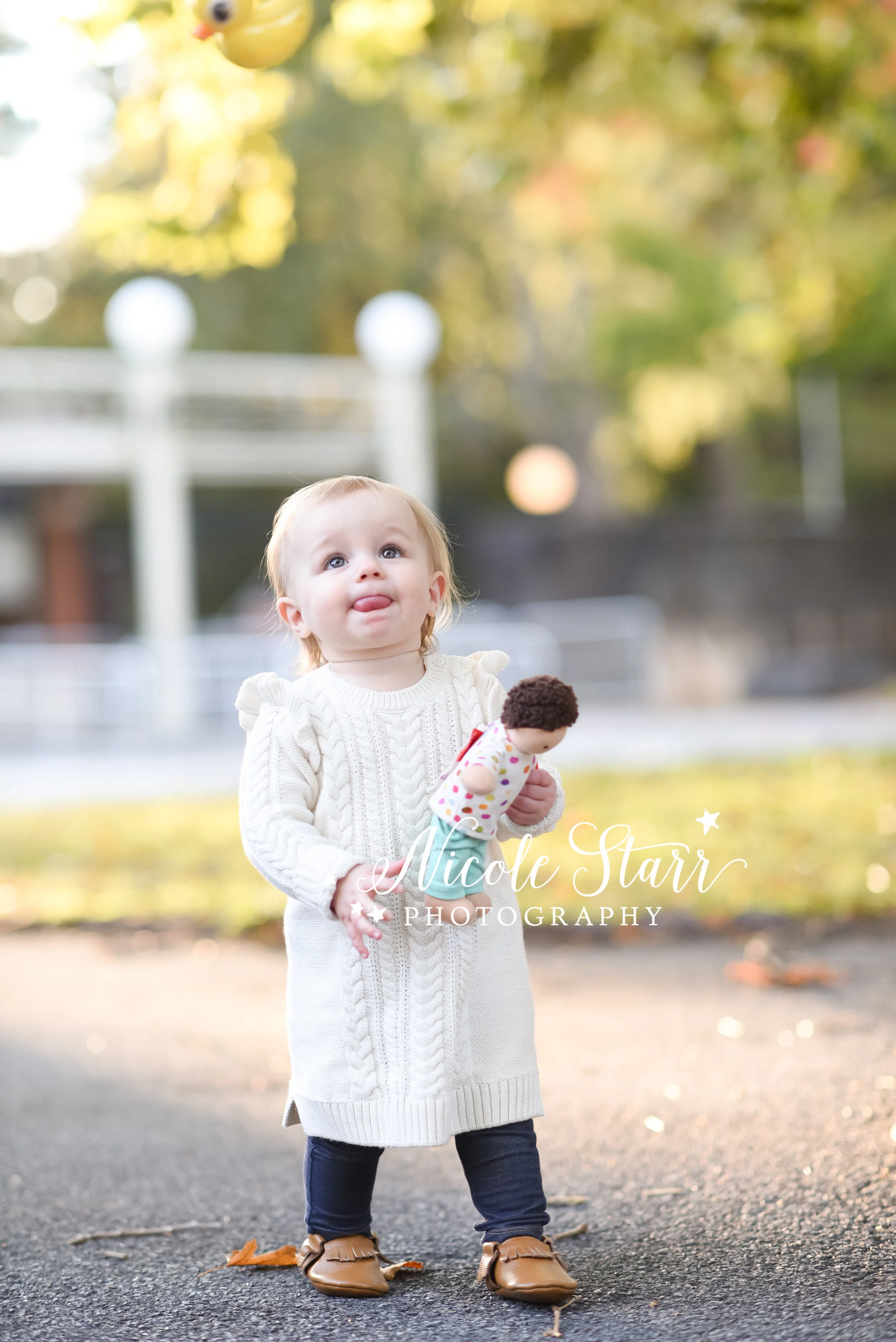 toddler girl in white sweater dress walks through Saratoga Spa State Park with Delmar NY family photographer Nicole Starr Photography