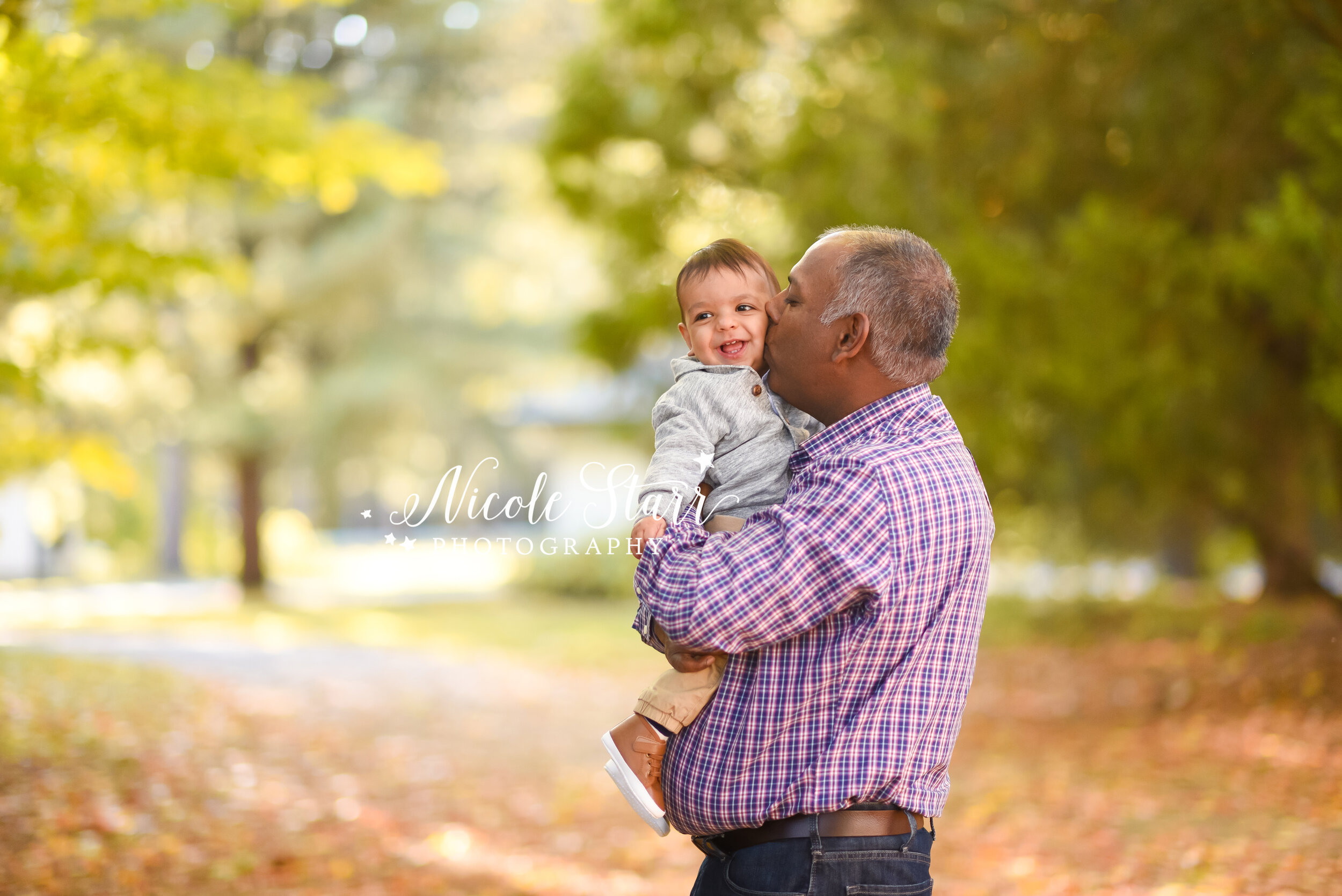 dad holds toddler during fall family photos with Saratoga Springs luxury portrait photographer Nicole Starr Photography
