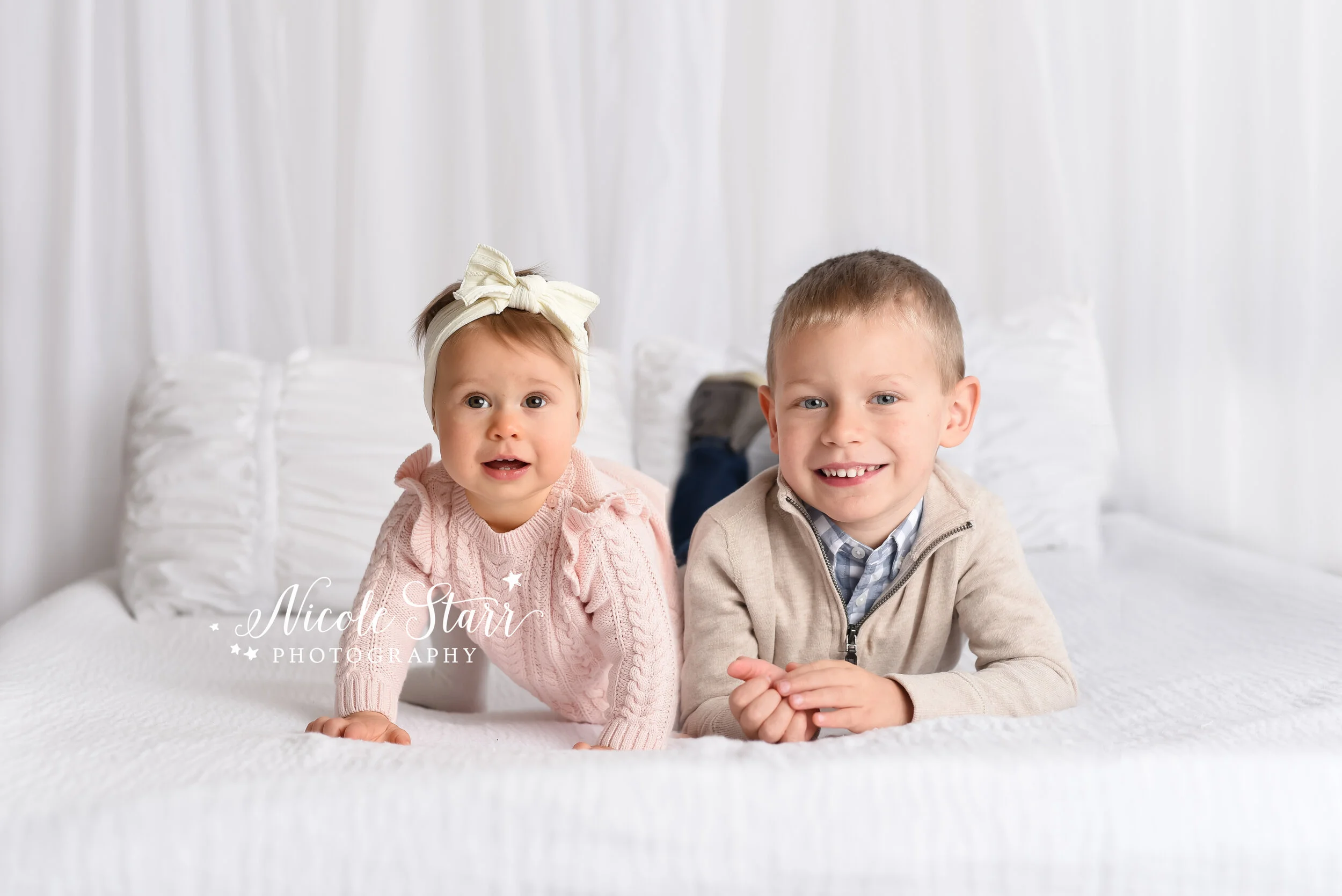 siblings play on bed photographed by New York family and baby photographer Nicole Starr Photography