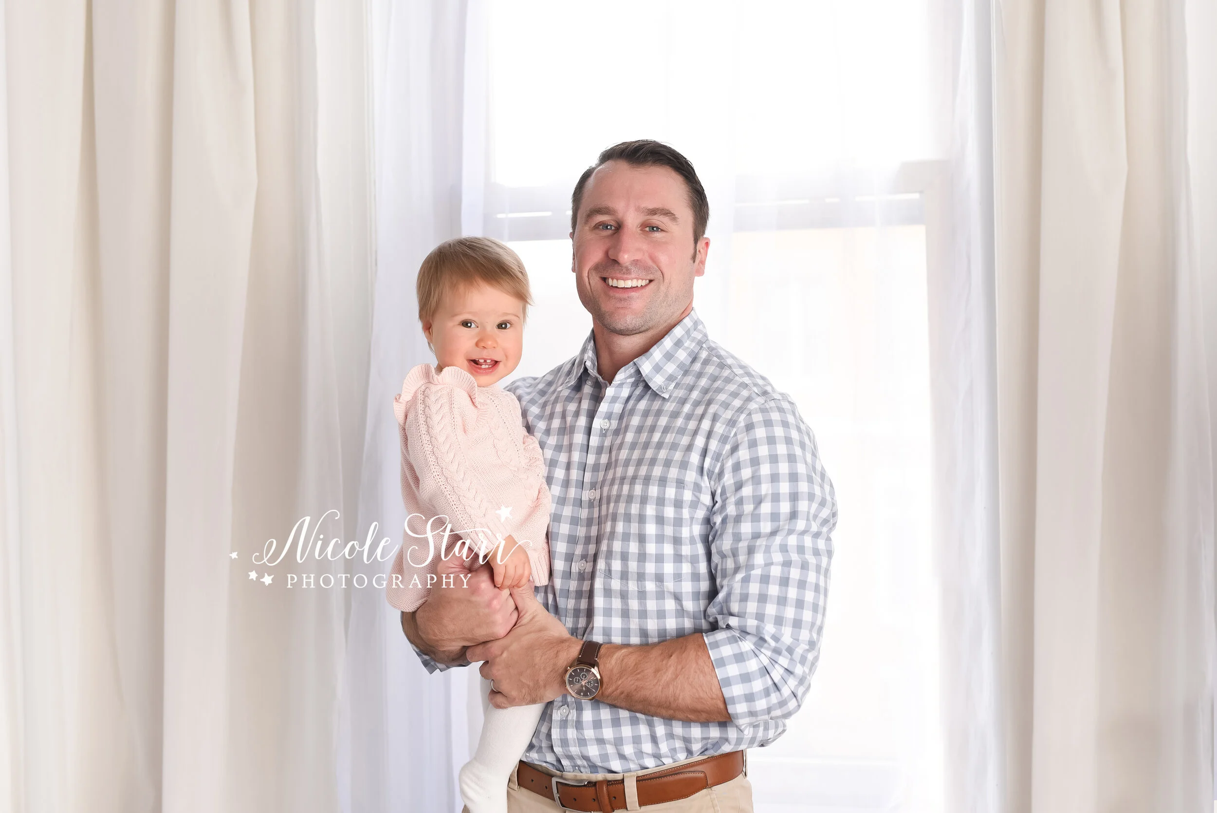 dad holds one year old daughter during family photos  photographed by New York family and baby photographer Nicole Starr Photography