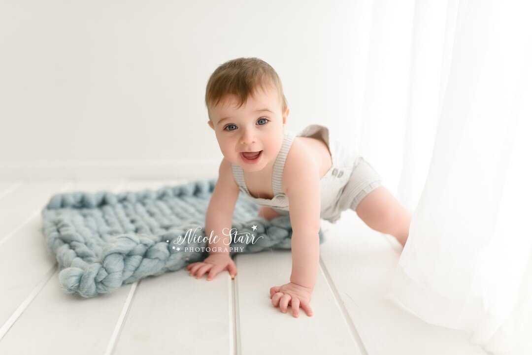 Jacob showed off his crawling skills and his adorable gummy smile during his milestone session this week!  Isn't he the cutest?! He reminds me so much of his big brother at this age, and there were a couple of moments during his session that I had de