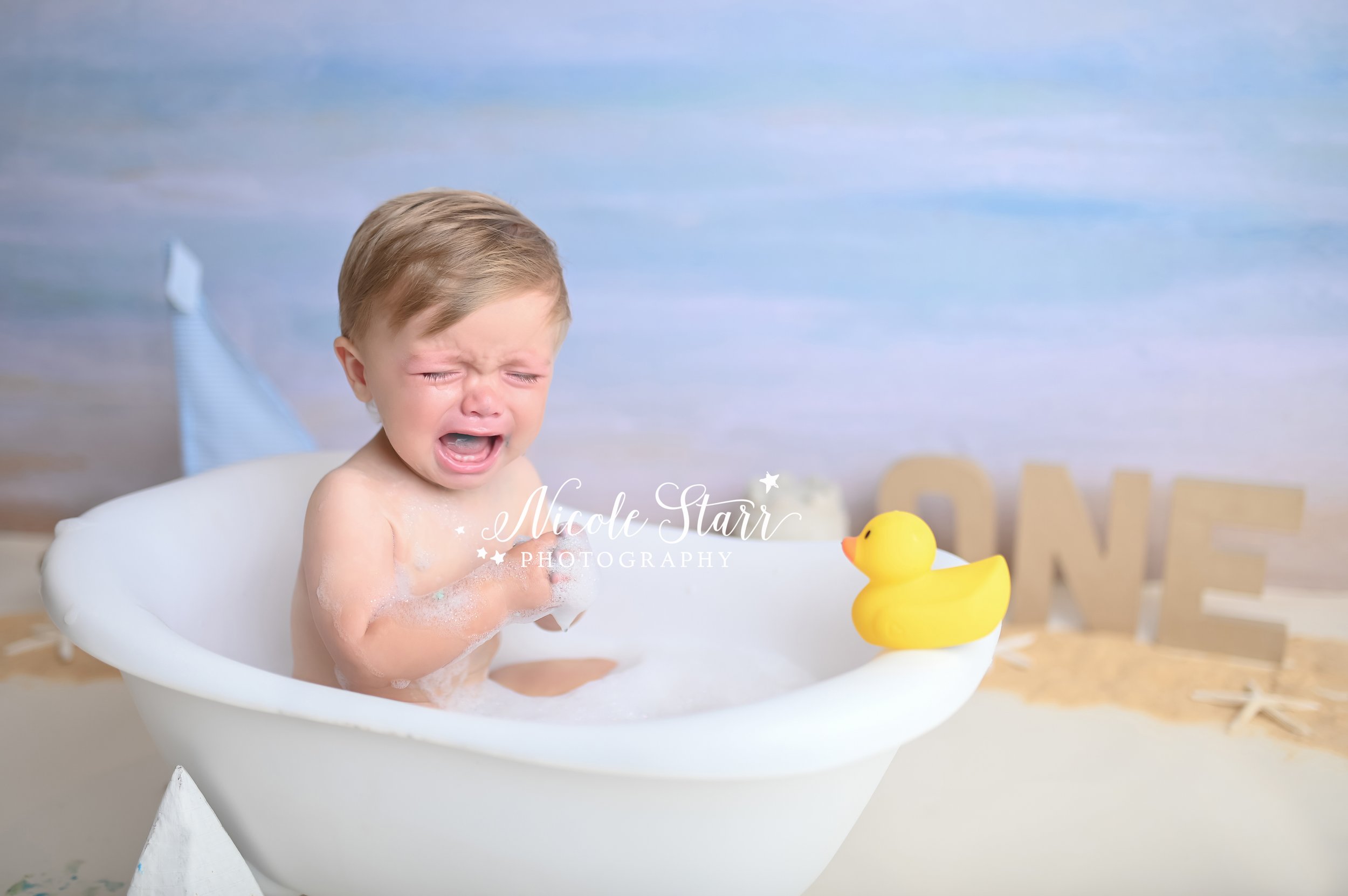 baby cries during cake smash with Saratoga Springs NY cake smash photographer Nicole Starr Photography 