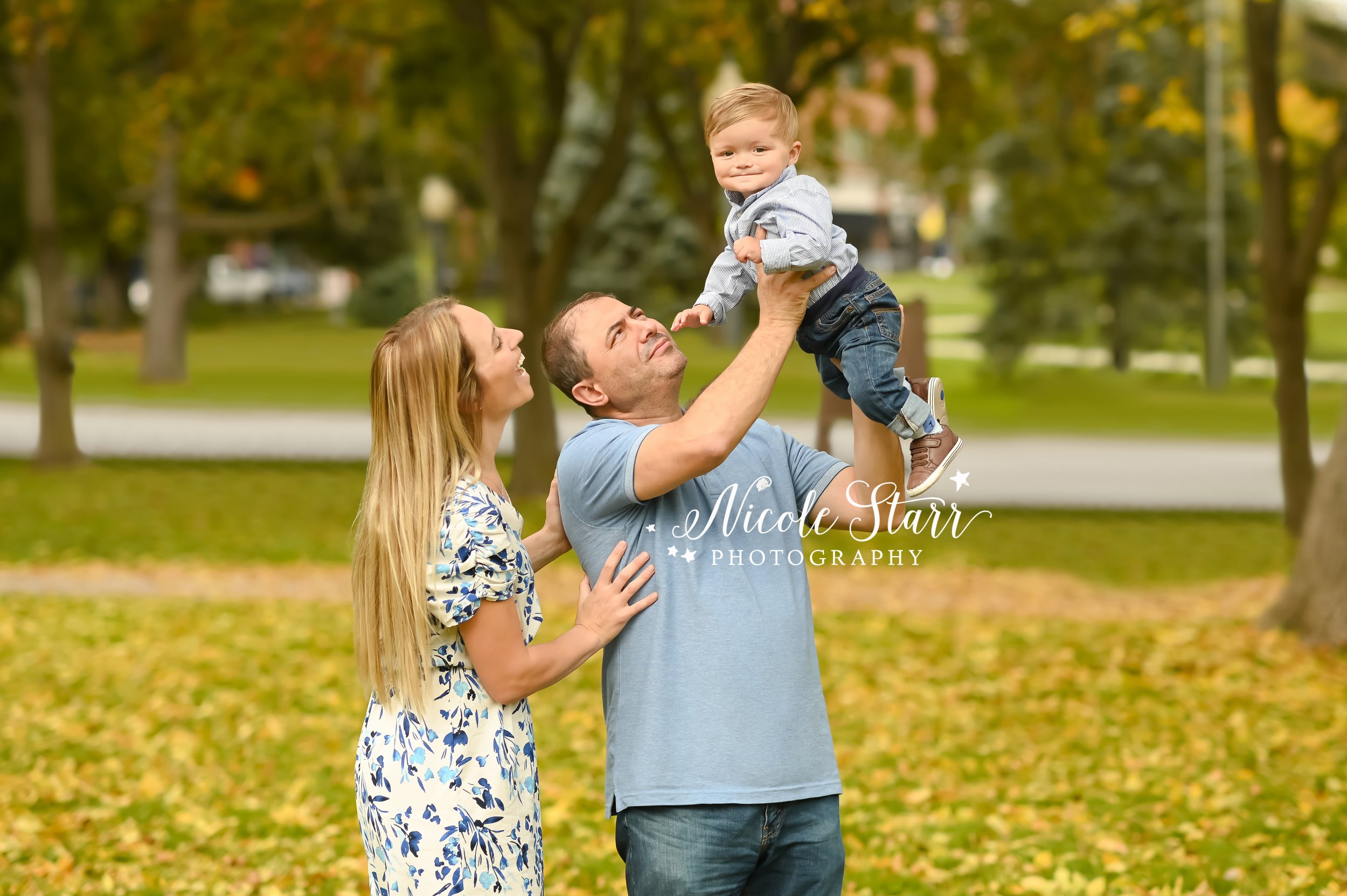 dad lifts son up during family photos with Saratoga Springs family photographer Nicole Starr Photography