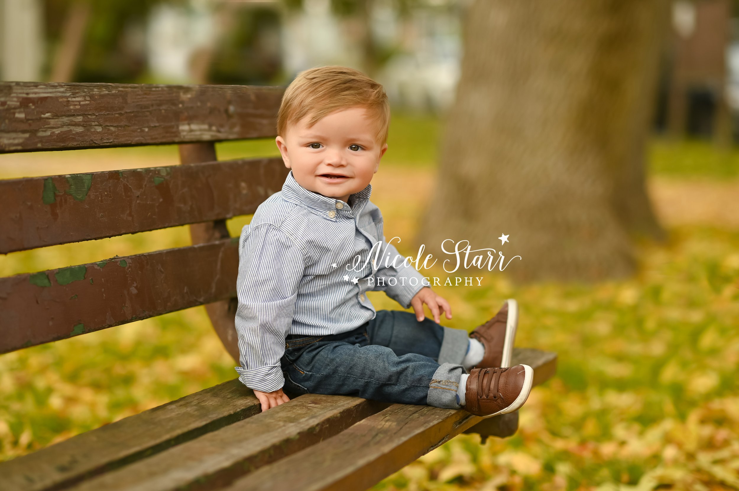 one year old sits on wooden bench photographed by Saratoga Springs family photographer Nicole Starr Photography