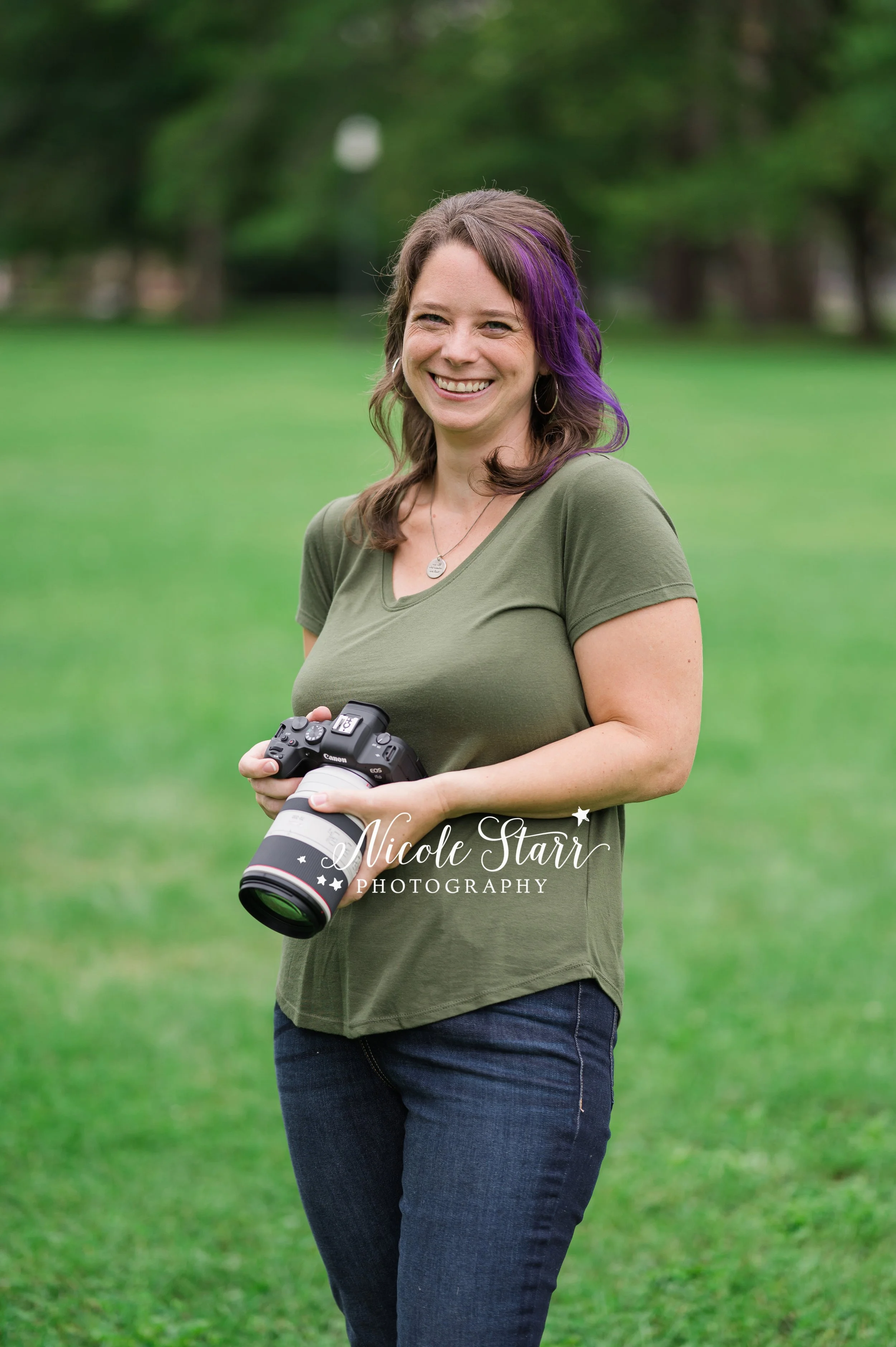 pet photographer with purple hair laughs holding camera during branding session photographed by Saratoga Springs branding photographer Nicole Starr Photography