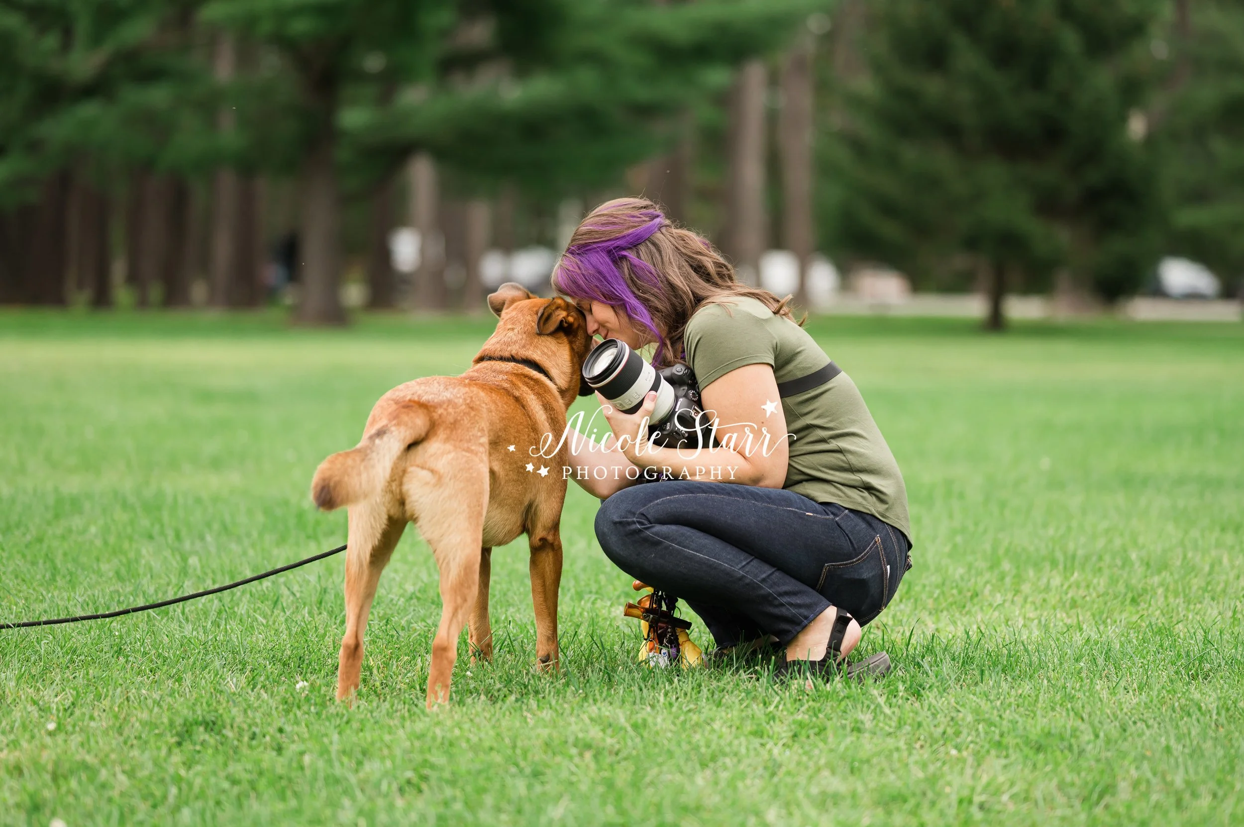 pet photographer with purple hair nuzzles dog while holding camera during branding session photographed by Saratoga Springs branding photographer Nicole Starr Photography