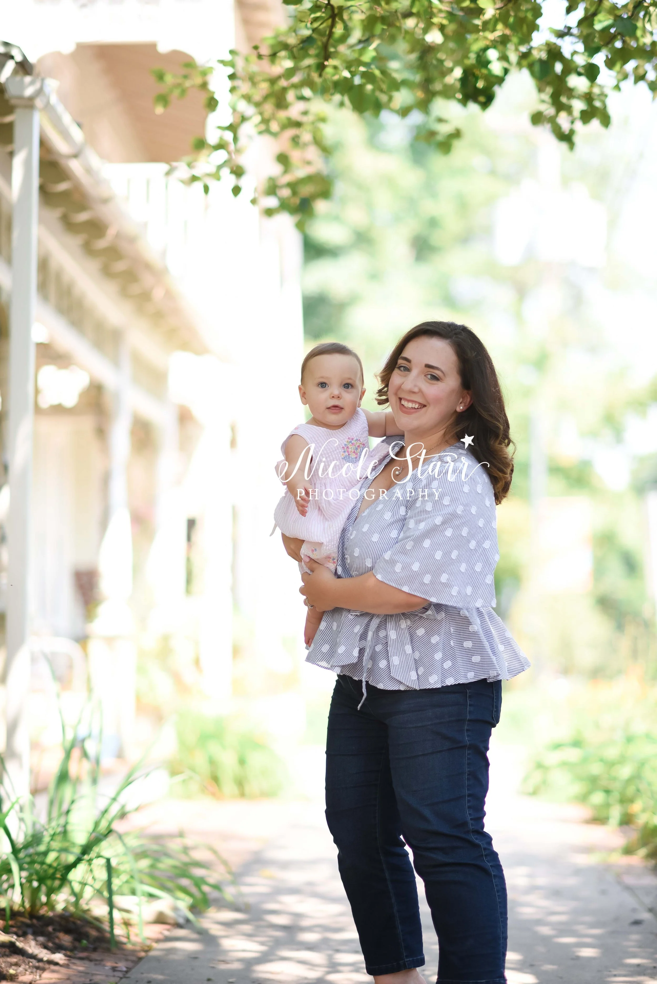mom holds baby on sidewalk during spring family photos with New York family photographer Nicole Starr Photography
