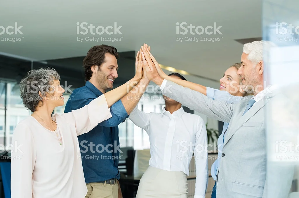 No-one does group-high fives in the office. No one. Source: istock.com