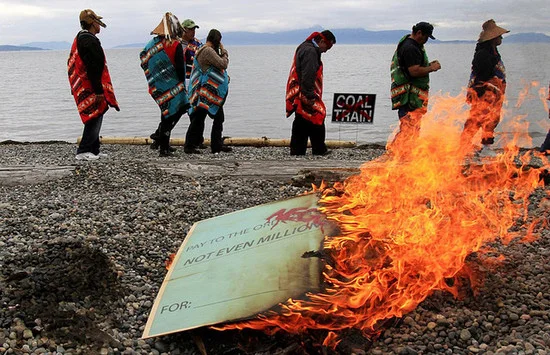 Lummi Nation Council symbolically burns a $1 million check from the terminal company (Credit: Blades ).