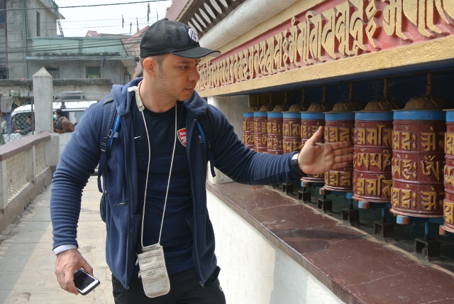Ten seconds after this picture, he got in trouble for turning the prayer wheel the wrong direction. He smiled and just switched direction. 