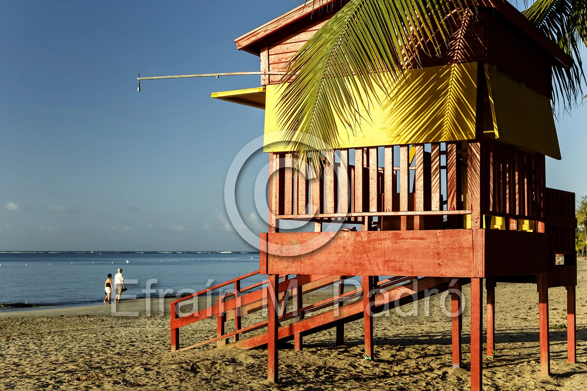 Lifeguard house and walking couple on beach, Luquillo Public Beach, Luquillo, Puerto Rico