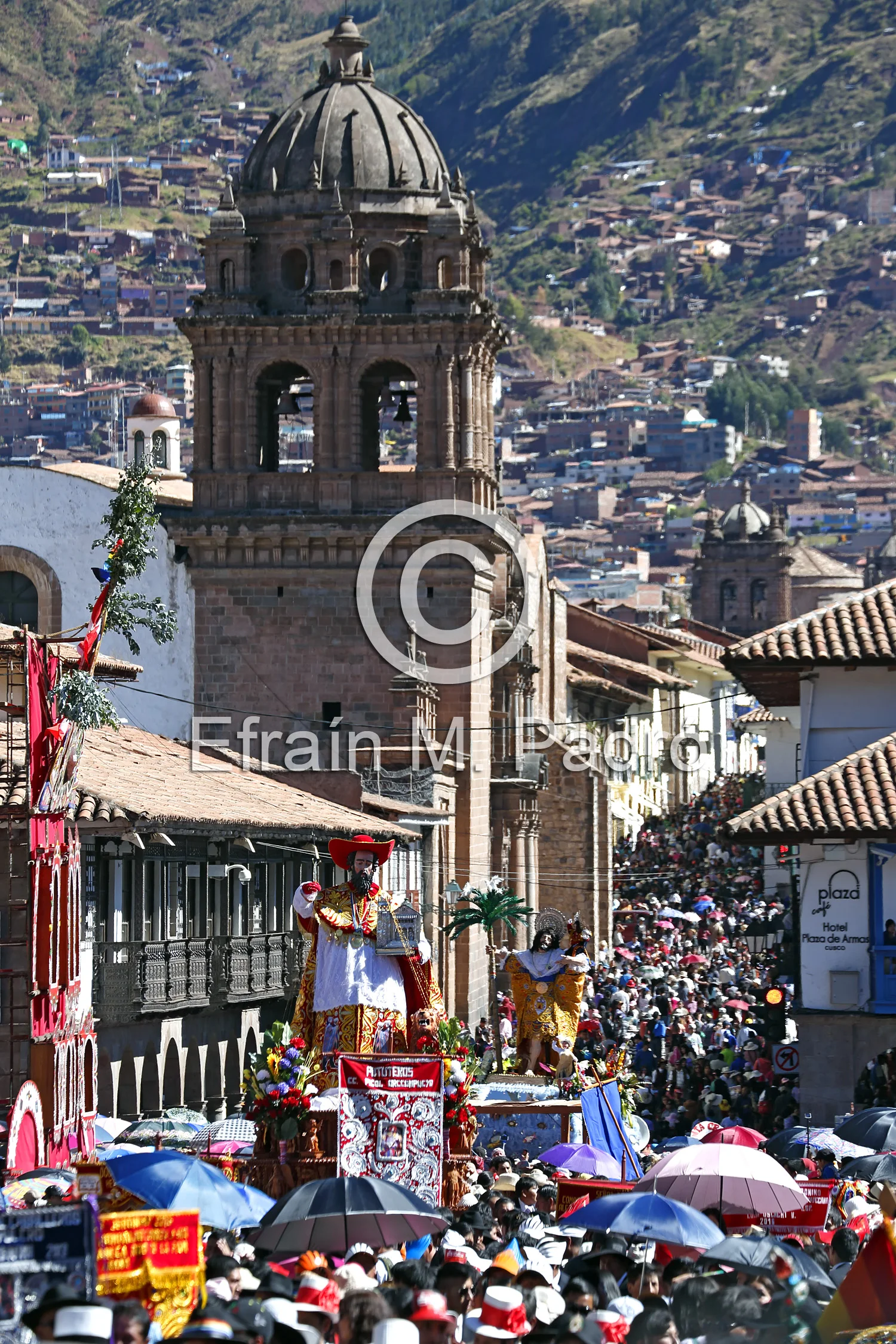 San Jeronimo (St. Geronimo) float (San Cristobal/St. Christopher float behind) and crowd, La Merced Church bell tower in background, procession, Plaza de Armas, Corpus Christi Celebration, Cusco, Peru