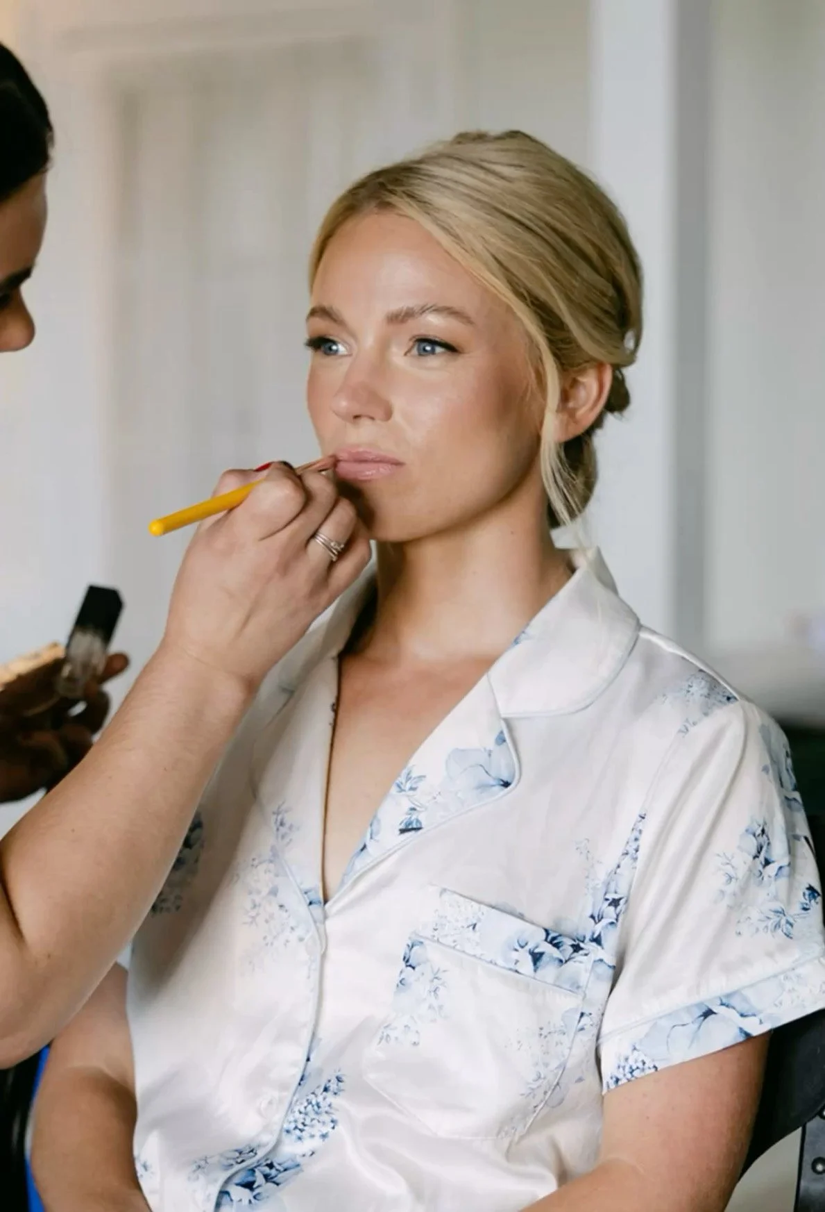 Luxury bridal makeup artist applying makeup to a bride on her wedding day