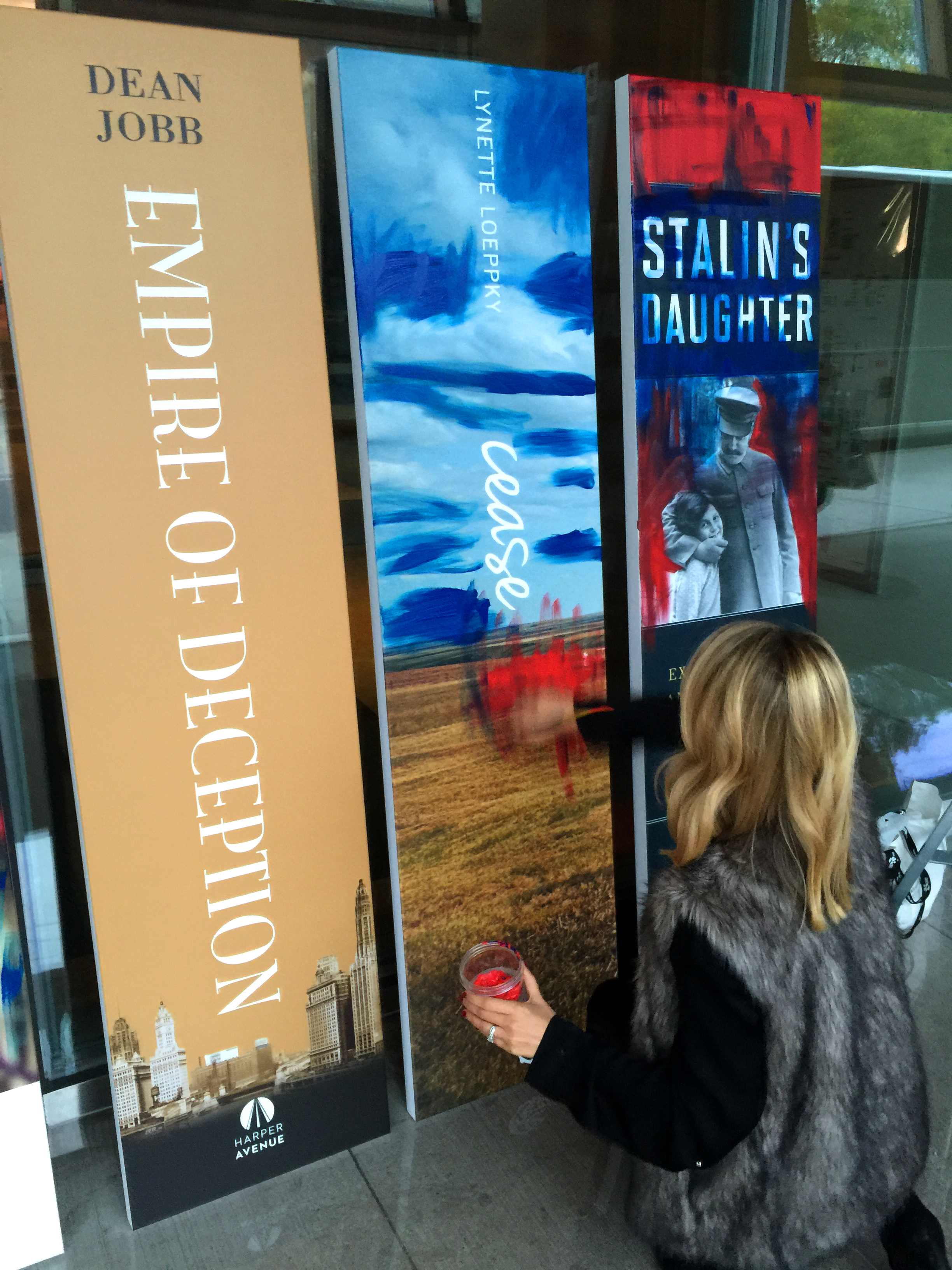 An artist works on a poster display of finalists for the Hilary Weston Writers’ Trust nonfiction award at the Oct. 6 gala in Toronto. Juan Opitz photo