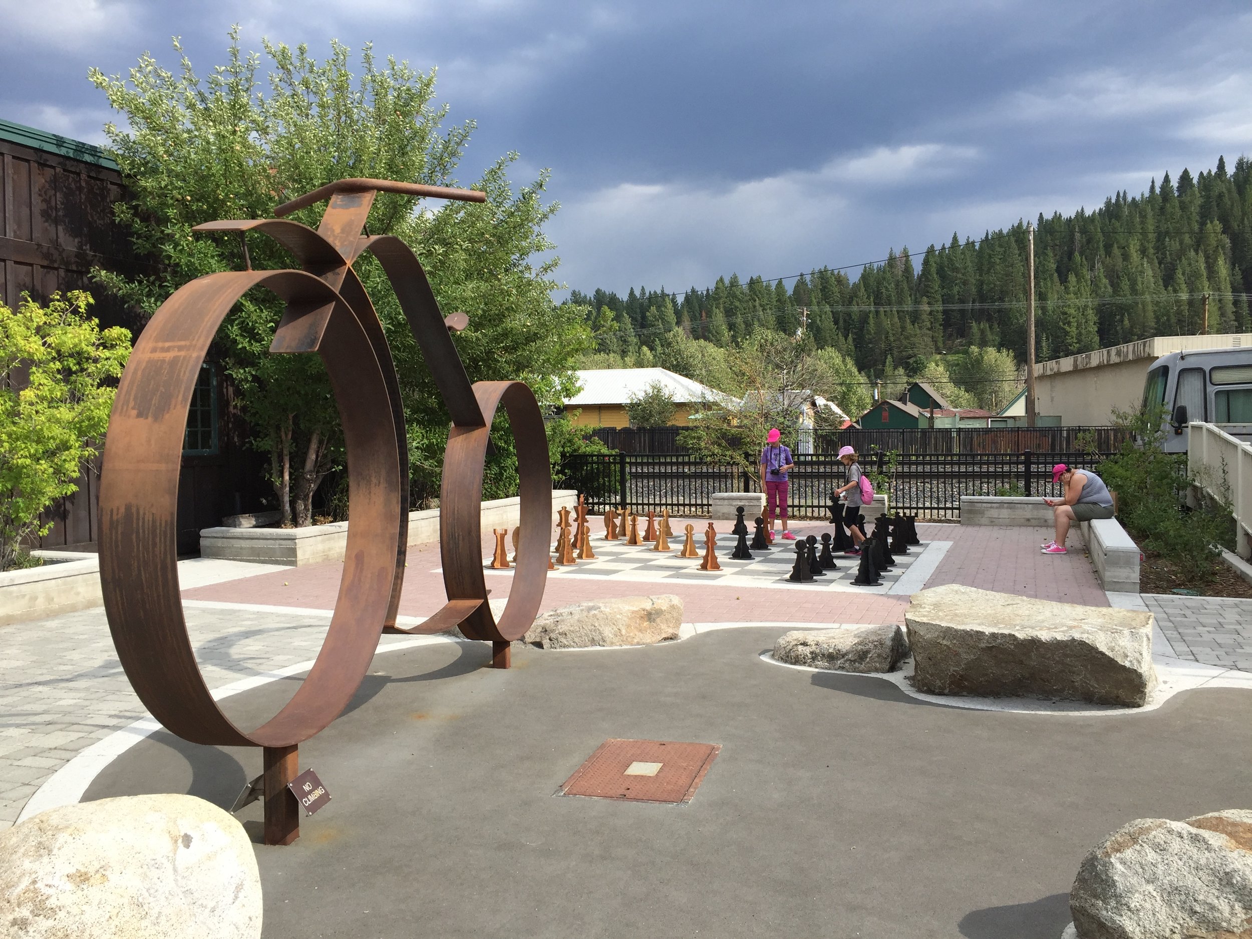 The Locomotion bike sculpture by local artist Fred Besch stands at the entrance to the mini plaza containing the chess board.