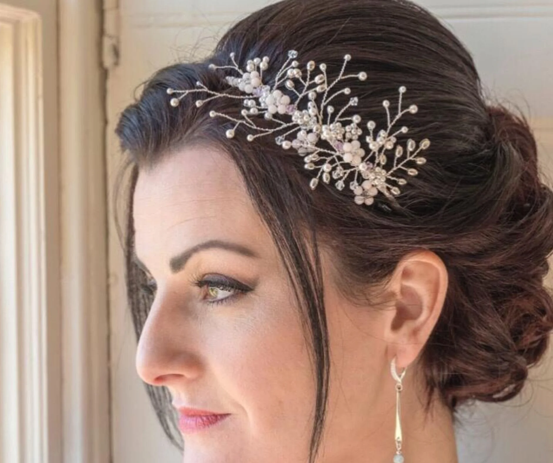 Pale pink floral tiara in brown hair.jpg