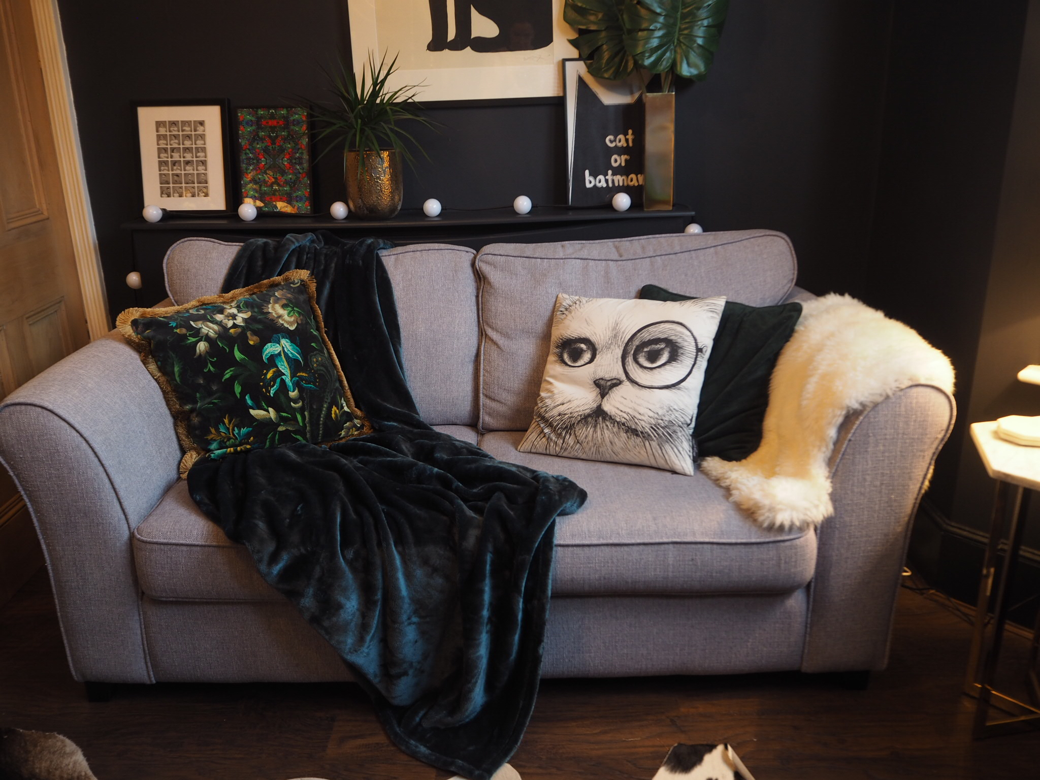 Cosy Autumn update with a plush green throw in the dark lounge 