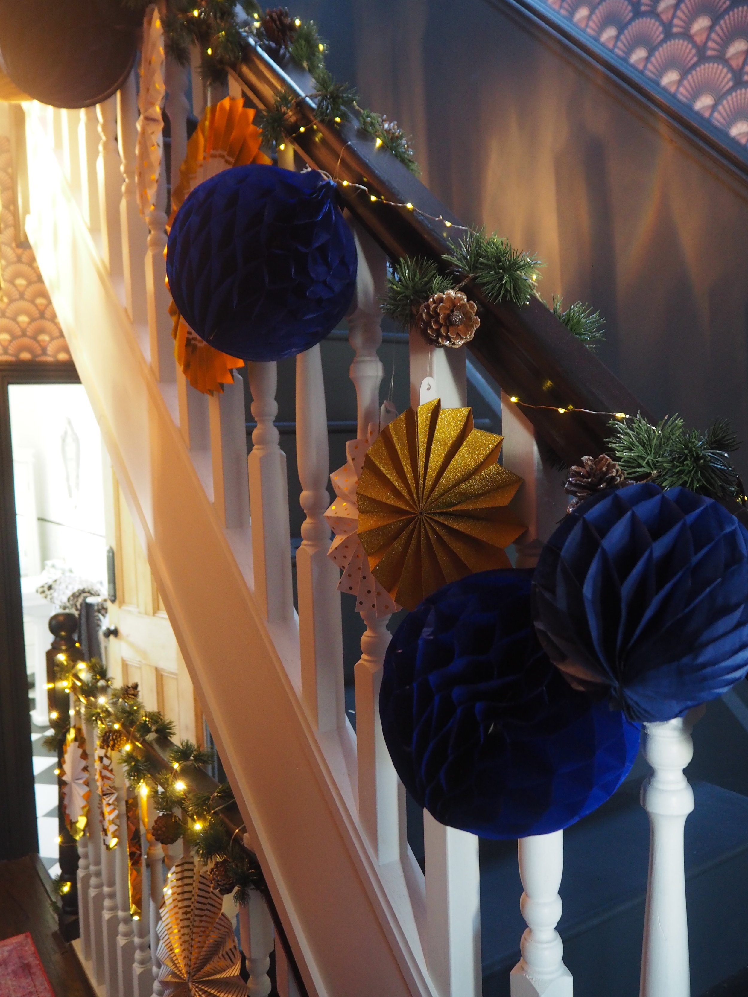 Decorating a Staircase with Honeycomb Balls by The Listed Home