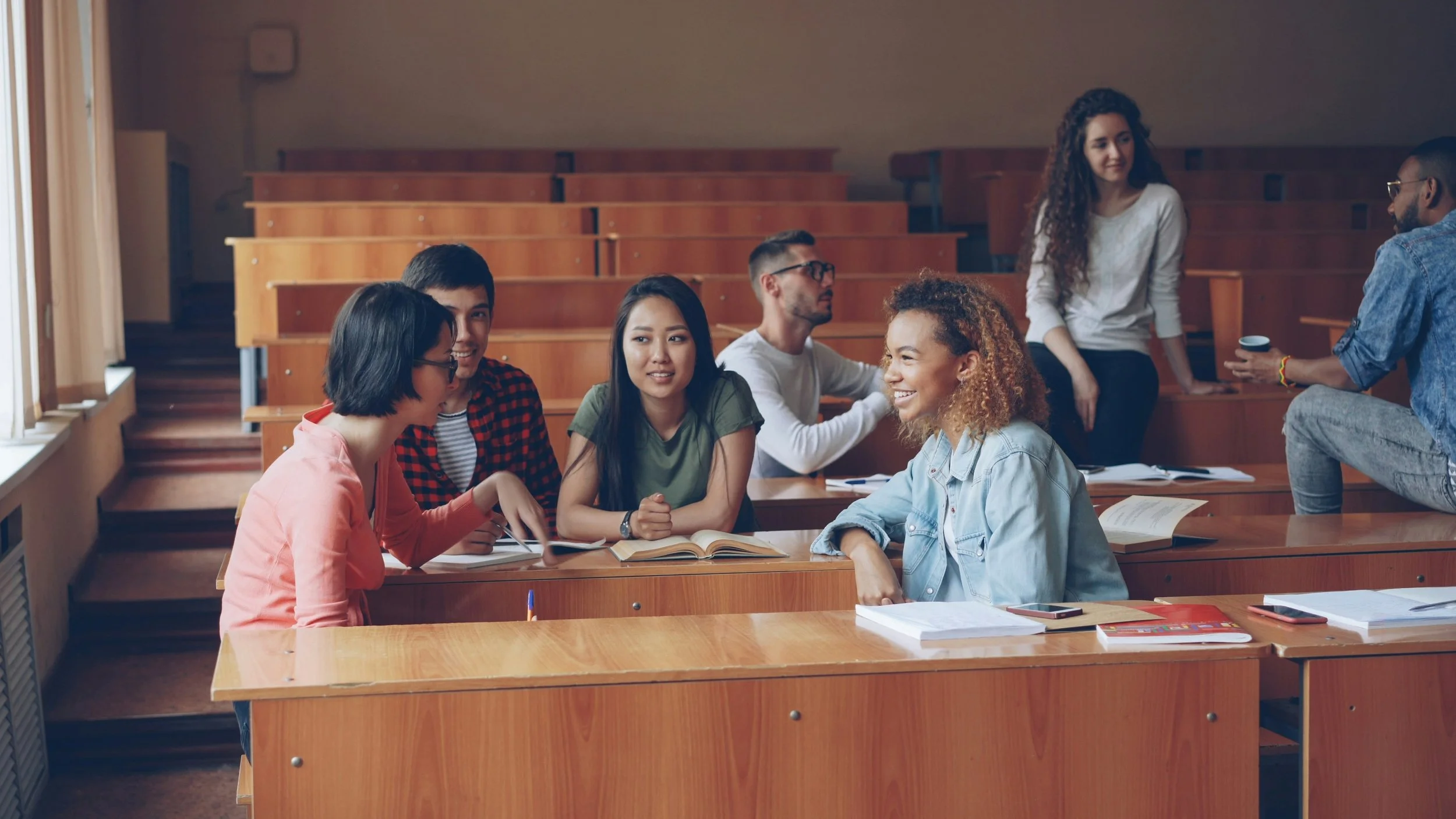 college students in classroom chatting
