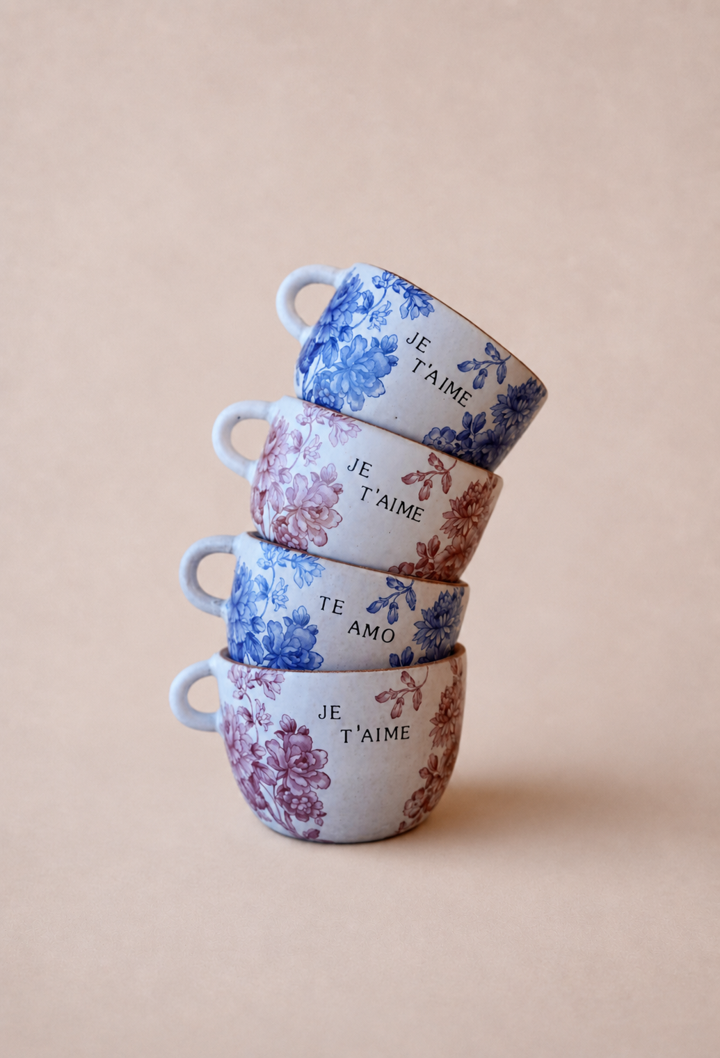 Floral ceramic cups on blush-beige backdrop.png