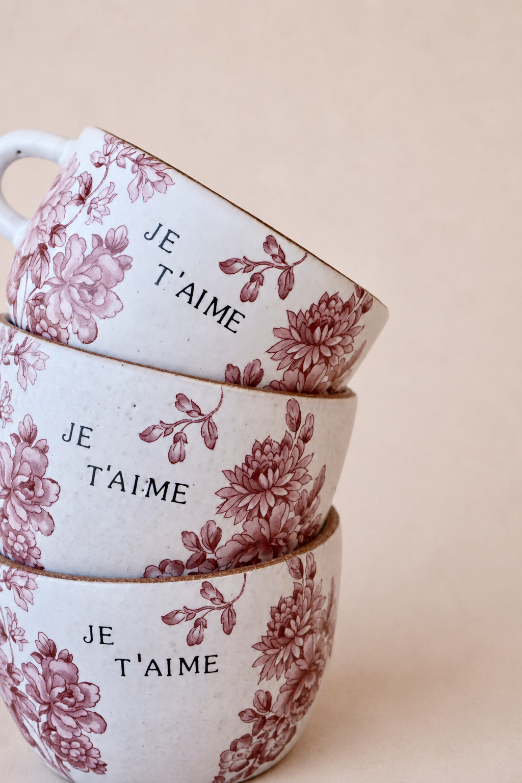 Floral ceramic cups on blush-beige sweep.png