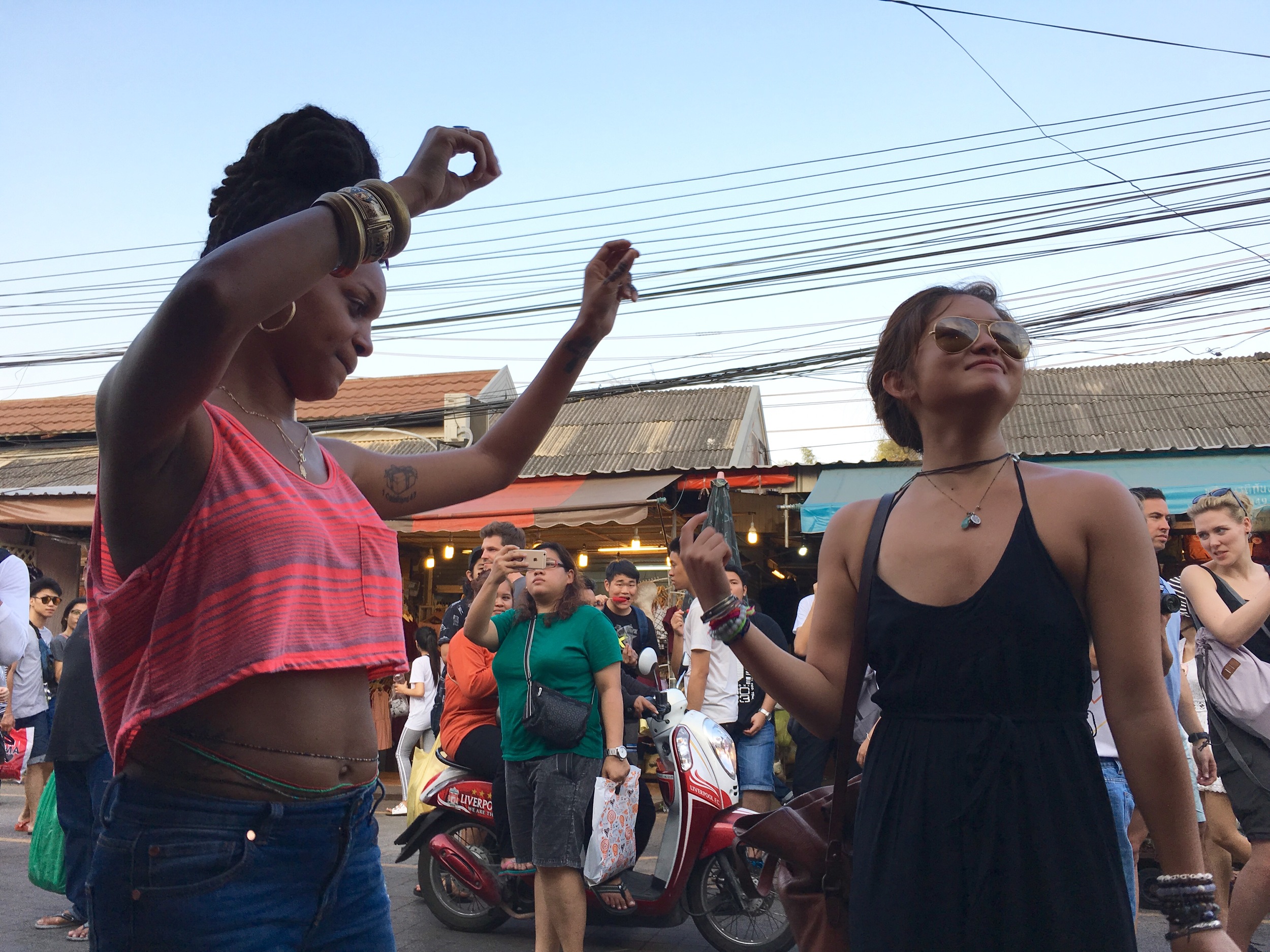 Dancing to music while enjoying lunch at the Chatuchak Weekend Market (aka JJ Market) in Bangkok, Thailand.
