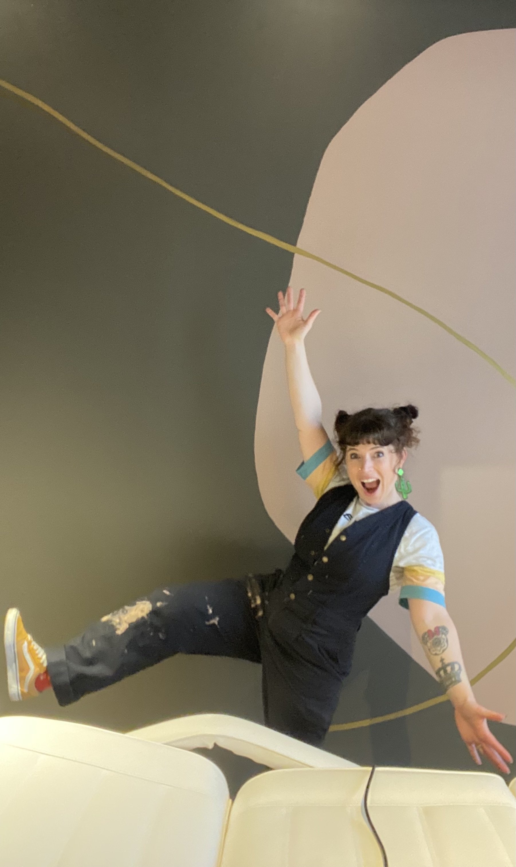 jess bracey does happy dance at tokyo head spa in front of mural.jpg