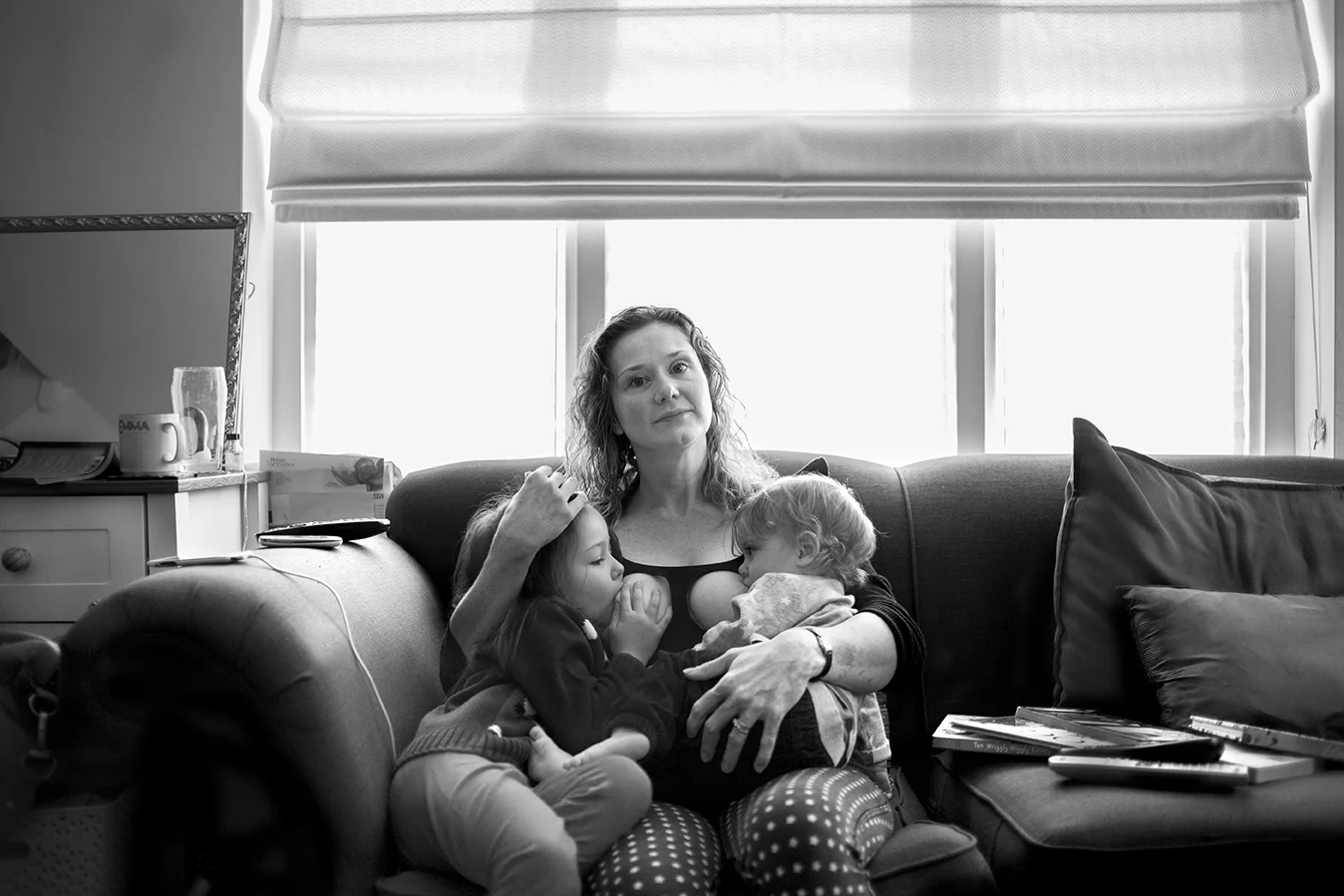 “My breastfeeding relationship has been all about learning and working. With my daughter I was in agony for ten weeks. We never really worked out why. But I kept going and suddenly it became pain free. So we carried on to three months, then six, then a year and then I couldn’t see a point in stopping when it was now so easy and such a great parenting tool. It calms tantrums (toddler and beyond!) so quickly and easily, offers comfort, and is a space to just be for both of us. Now she’s six it’s infrequent. Her adult teeth are coming in, her jaw shape is changing. She actually can’t get milk any more. But still asks to nurse to reconnect, chill out, and just be close. She will stop when she’s ready. I didn’t plan this. I told a friend “I’m not going to be like you, feeding a child at school”, but actually it’s easy and natural and normal (biologically speaking) and the gift of natural term weaning is one of the greatest I can give to my child. My son is 16 months, still tiny and loves feeding. He had a tongue tie so it was very hard for the month before it was cut. Painful, with him not getting enough. One day we had no wet nappies at all. But I kept going and trusted my body and once the tie was cut he latched on and within a few days would suck for comfort and not just food. It felt like a miracle. But then birth and breastfeeding are miracles. I feed in public. Any time, anywhere. I walk around places with my boy in my arms, latched on, while I chat to people, order coffee, tidy up, whatever. I fed my daughter in public till she was three, then I felt conscious. But this time I will feed in public longer. I feel more confident about natural term weaning now. I love being able to tandem feed. Sometimes they hold hands. Sometimes my son tries to unlatch his sister, poking his finger in her mouth, or pokes her eyes. He shares his boobs reluctantly! My mum fed me till I was five months. I didn’t ever consider any other way to feed my babies. I trust my body to feed them. Formula was never an option. I have friends who would wet nurse for me, and I for them, if it was ever necessary. My advice to others? Just do it. Other people’s opinions don’t matter. Not even your partner’s. Get the right support and do what’s right for you and your child.”