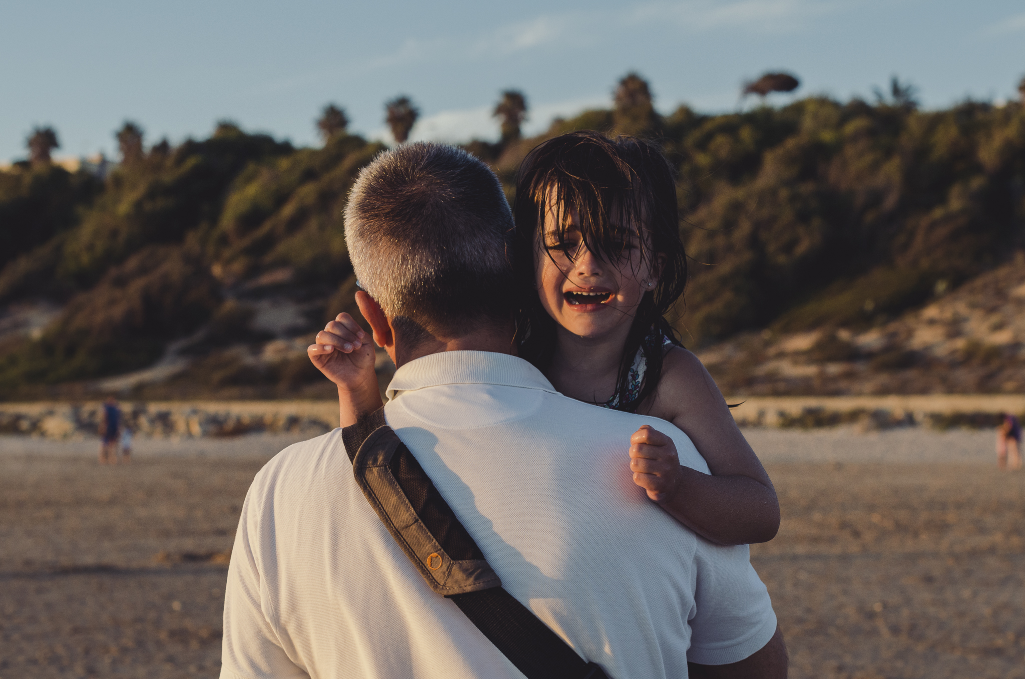 Crying girl with dad at the beach