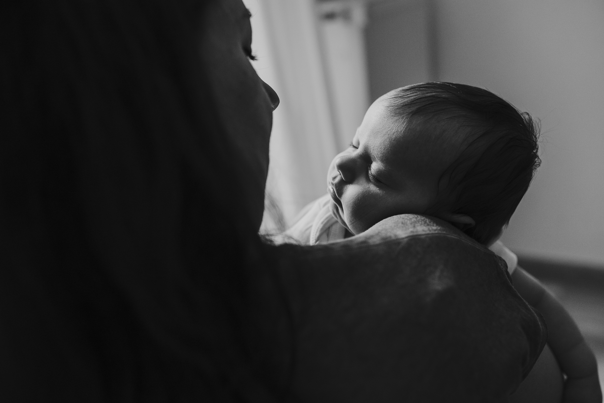 Sleeping baby on moms arms.jpg