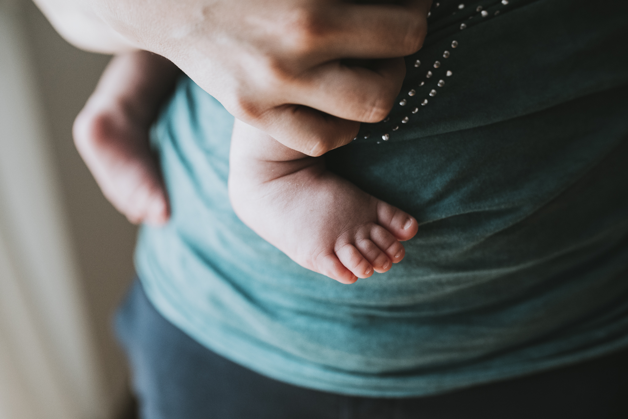 Baby feet on moms arms.jpg