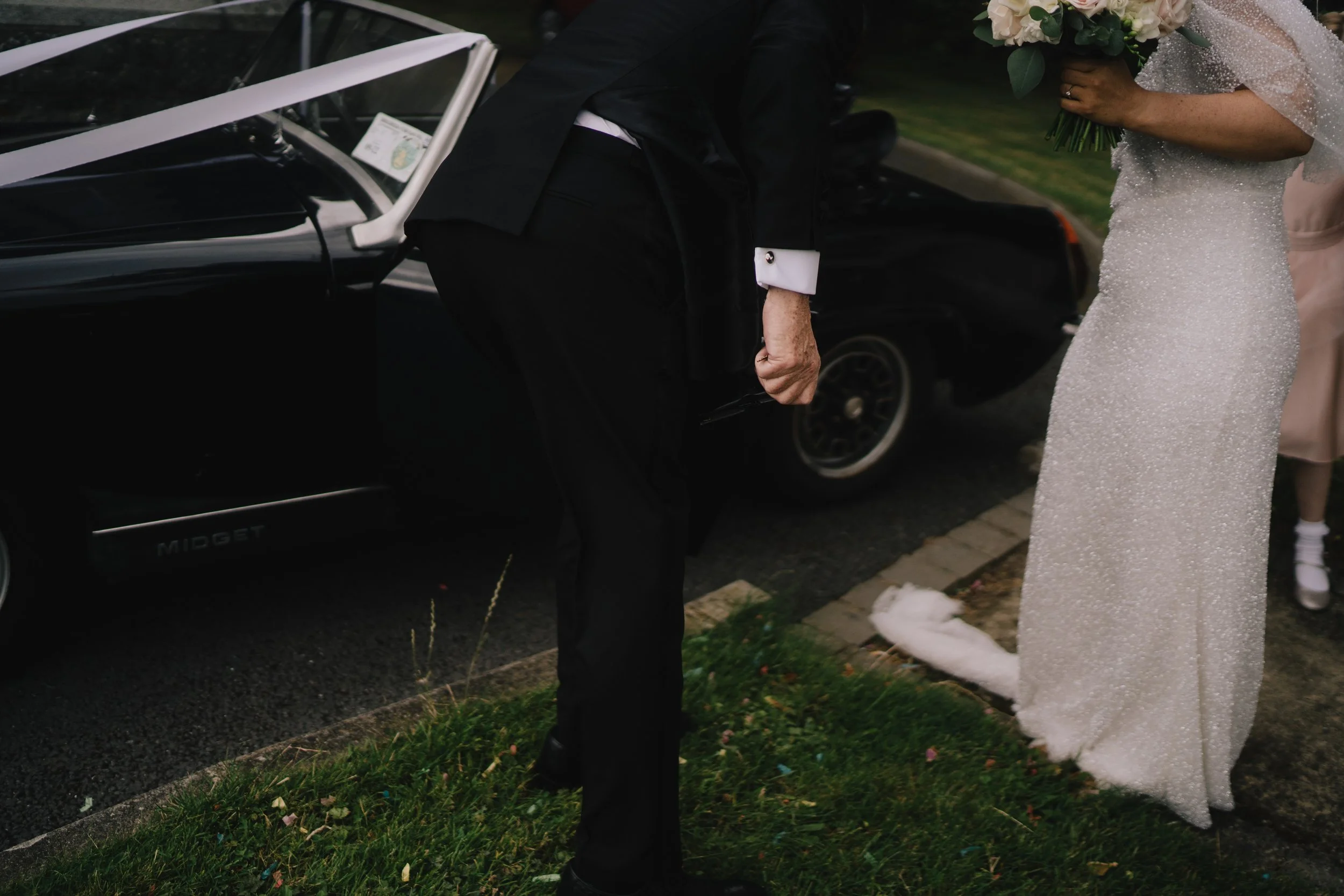 couple at the side of classic car