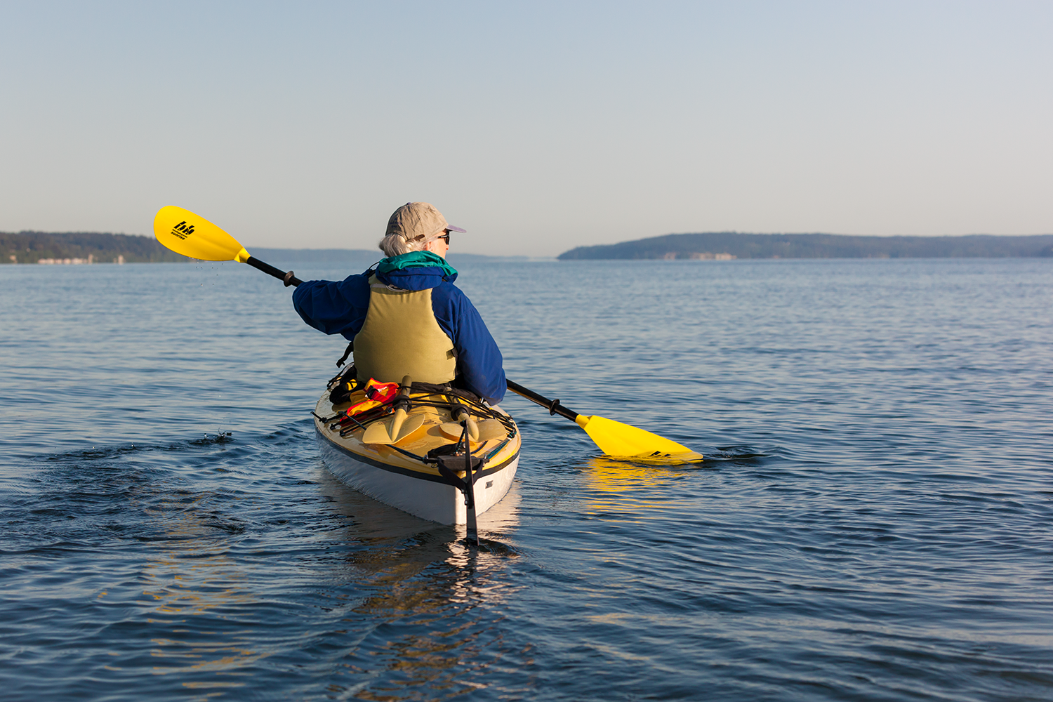Kayakers on a group tour off Whidbey Island with Cascade Mountain views