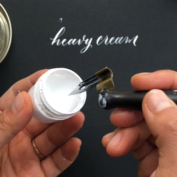 Dipping calligraphy nib into bleedproof white.png