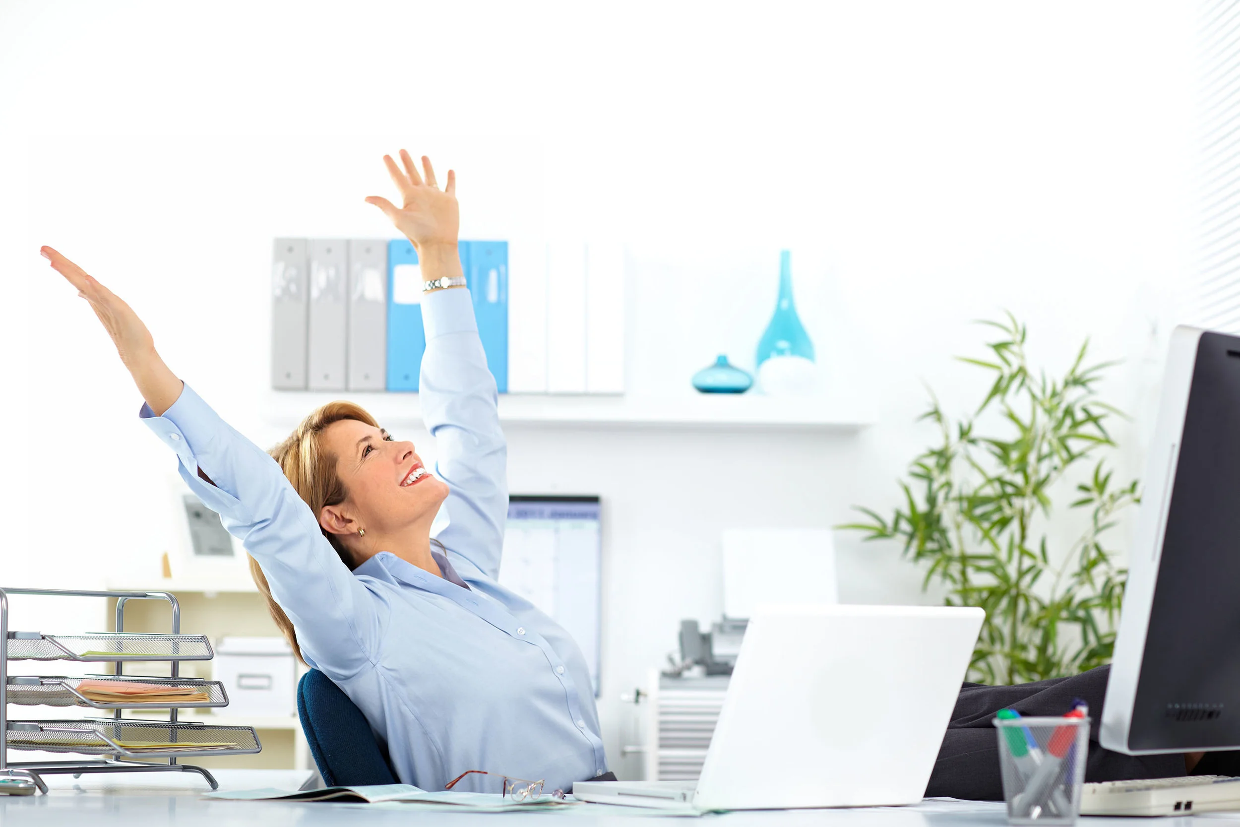 49253879 - beautiful mature business woman relaxing in modern office.