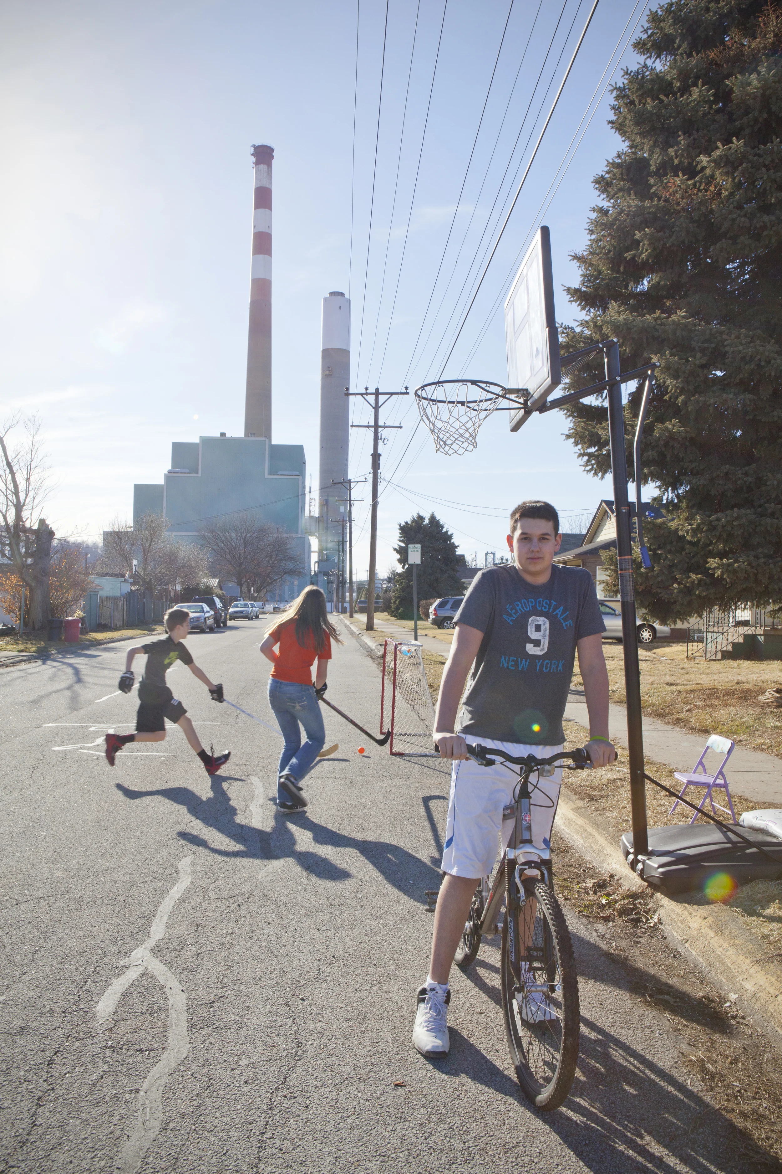 Children play on their street, next to power plant, Springdale, PA. 