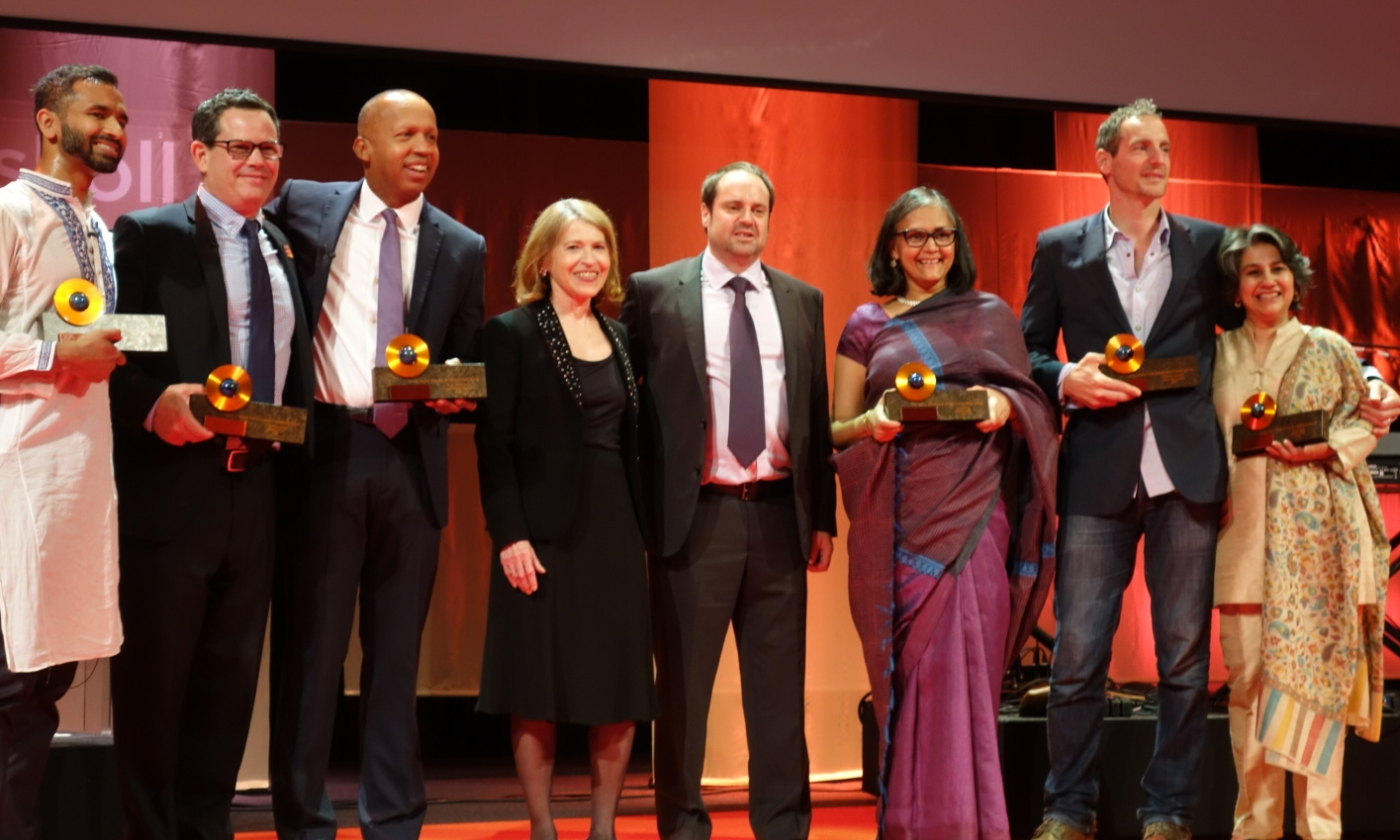 Skoll Awardees Vivek Maru, Chuck Slaughter, Bryan Stevenson, Skoll Foundation CEO Sally Osberg, Jeff Skoll, and Skoll Awardees Mallika Dutt, Oren Yakobovich and Sonali Khan.