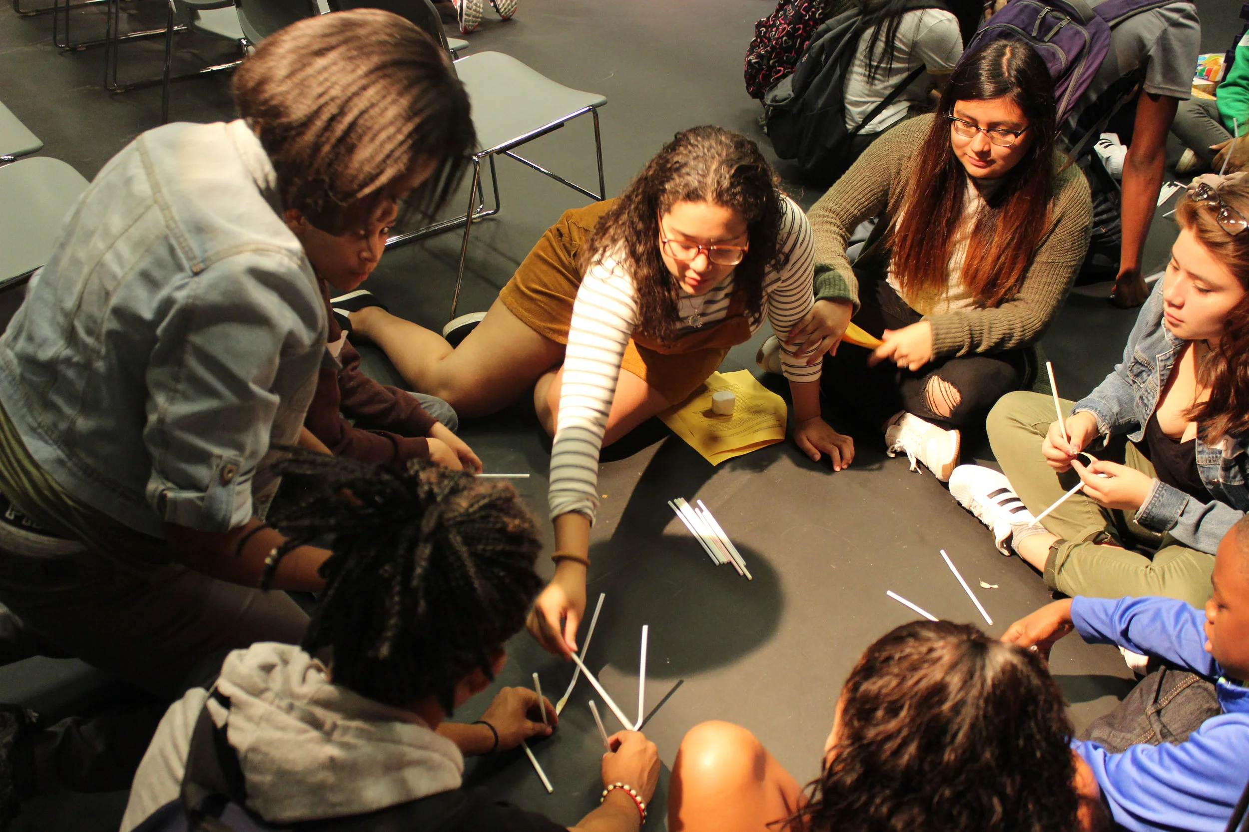 Alumni Jailine Estrella, center, current NYU freshman, attempts to spread ideas without speaking