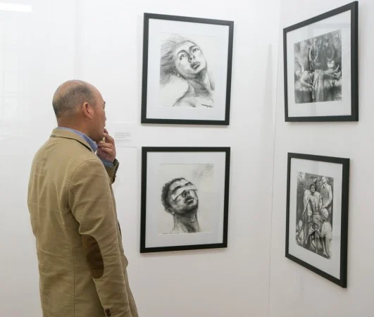 People attend an art exhibition by AAFOH (Artists Against Forced Organ Harvesting) in New York on May 10, 2016. (Benjamin Chasteen/Epoch Times)