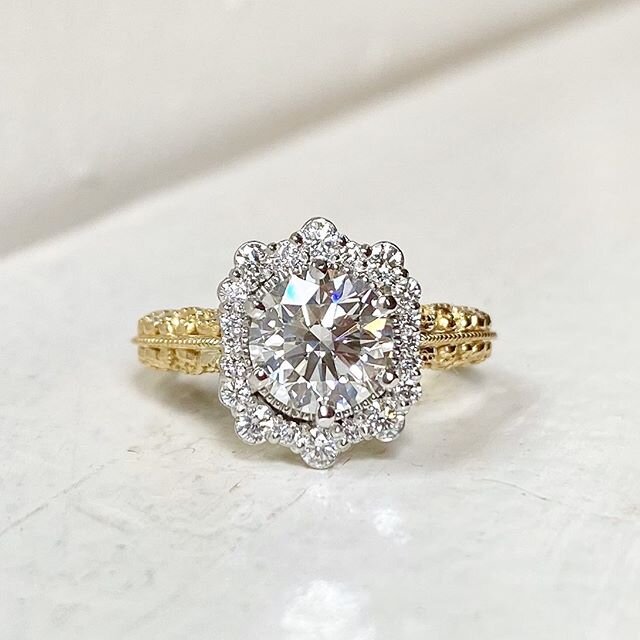 One beautiful couple was made very happy with the delivery of this custom knockout today! Their insanely gorgeous 1.4ct round center diamond is perfectly showcased by the uniquely shaped platinum halo, and on an arabesque style 18k yellow gold filigr