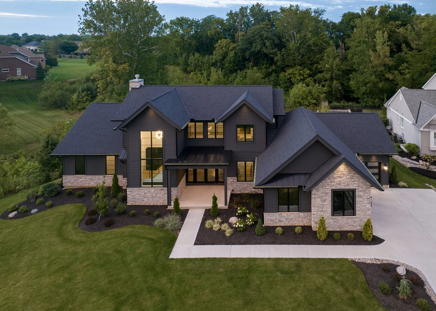 drone view of dark night two story, six-bedroom family home