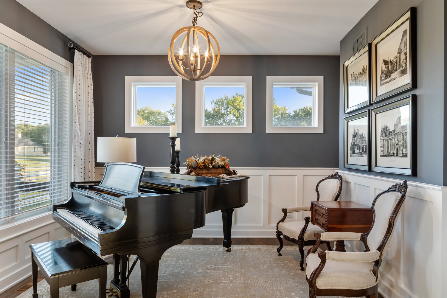 Elegant sitting area with a grand piano, antique chairs, and charming decor pieces.
