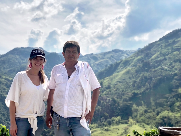 Maria Palacio, CEO of Progeny Coffee with a coffee farmer in Colombia.