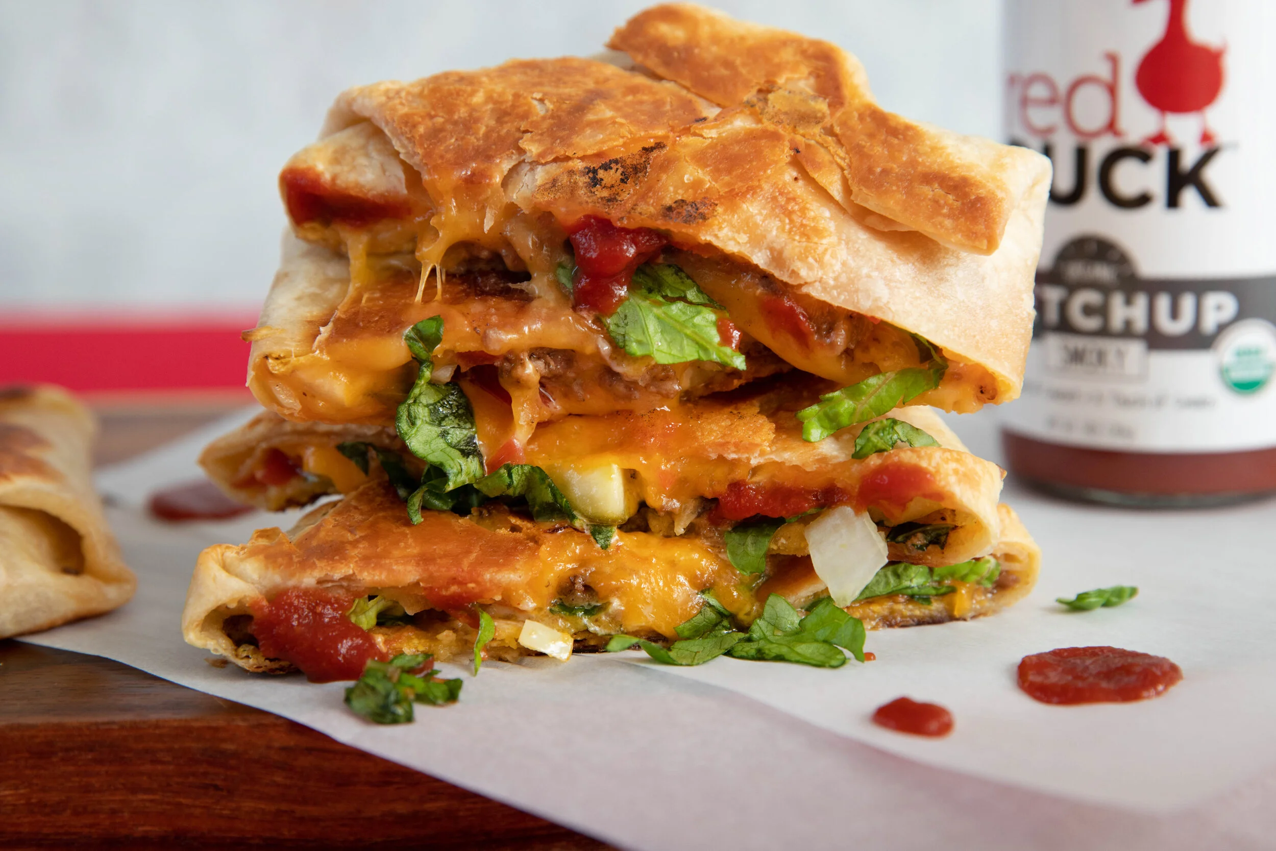 RedDuck_CheeseburgerCrunchwrap_BrandedHorizontal1.jpg