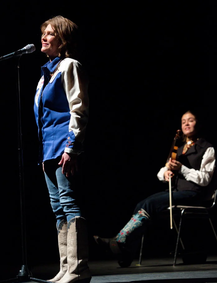 Amy Hale Auker storytelling at The Moth show with Brigid Reedy playing musical interludes.