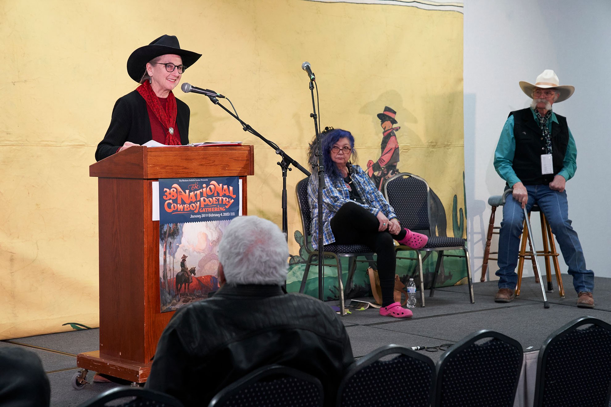  Maria Lisa Eastman (left, at podium) with nila northsun (center) and Floyd Beard (right) during the  In Earth’s Arms  session. Photo by Marla Aufmuth. 